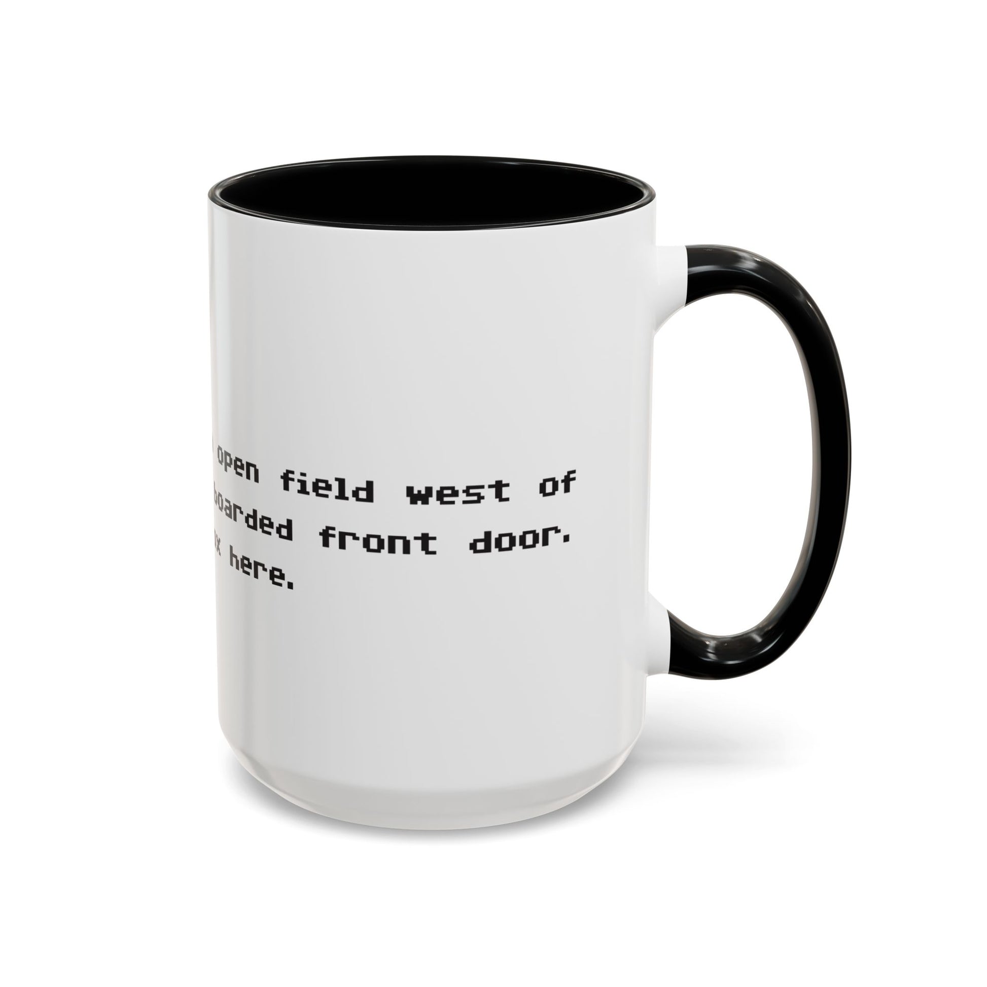Right handle view of 15 oz White ceramic accent mug with black handle and interior, Zork “West of House” opening line text wrapped in black print