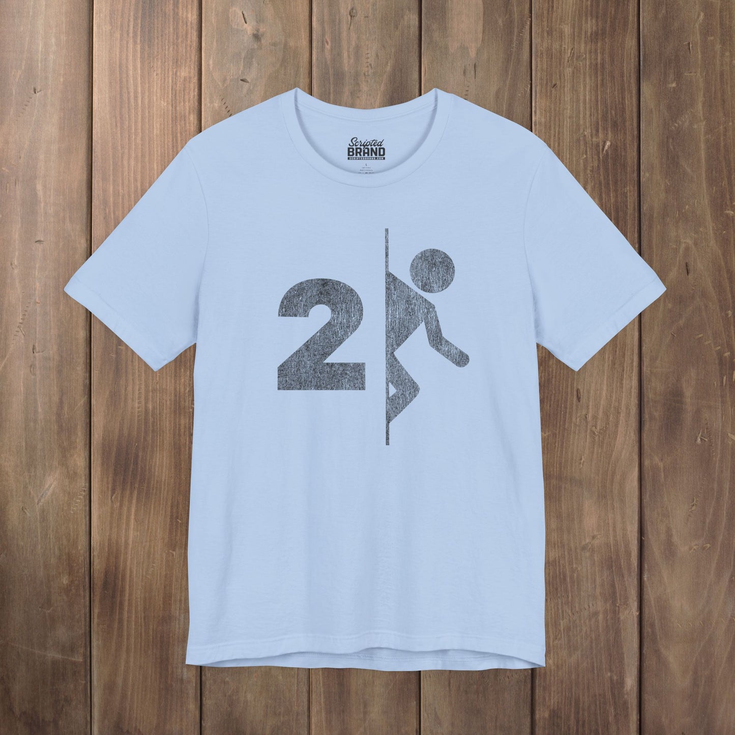 Light blue tee with vintage distressed Portal 2 partial logo figure diving through a portal, aperture labs