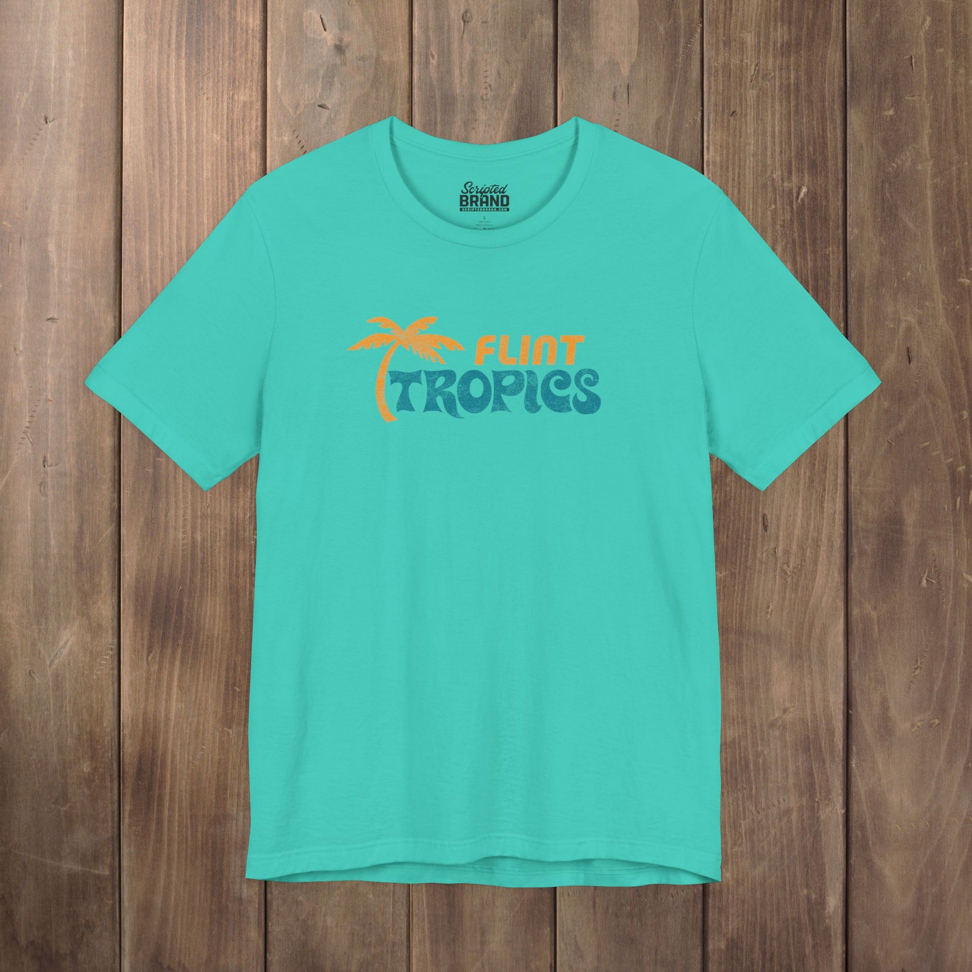 Teal Bella+Canvas t-shirt with the Flint Tropics logo from the movie Semi-Pro in a vintage distressed style.