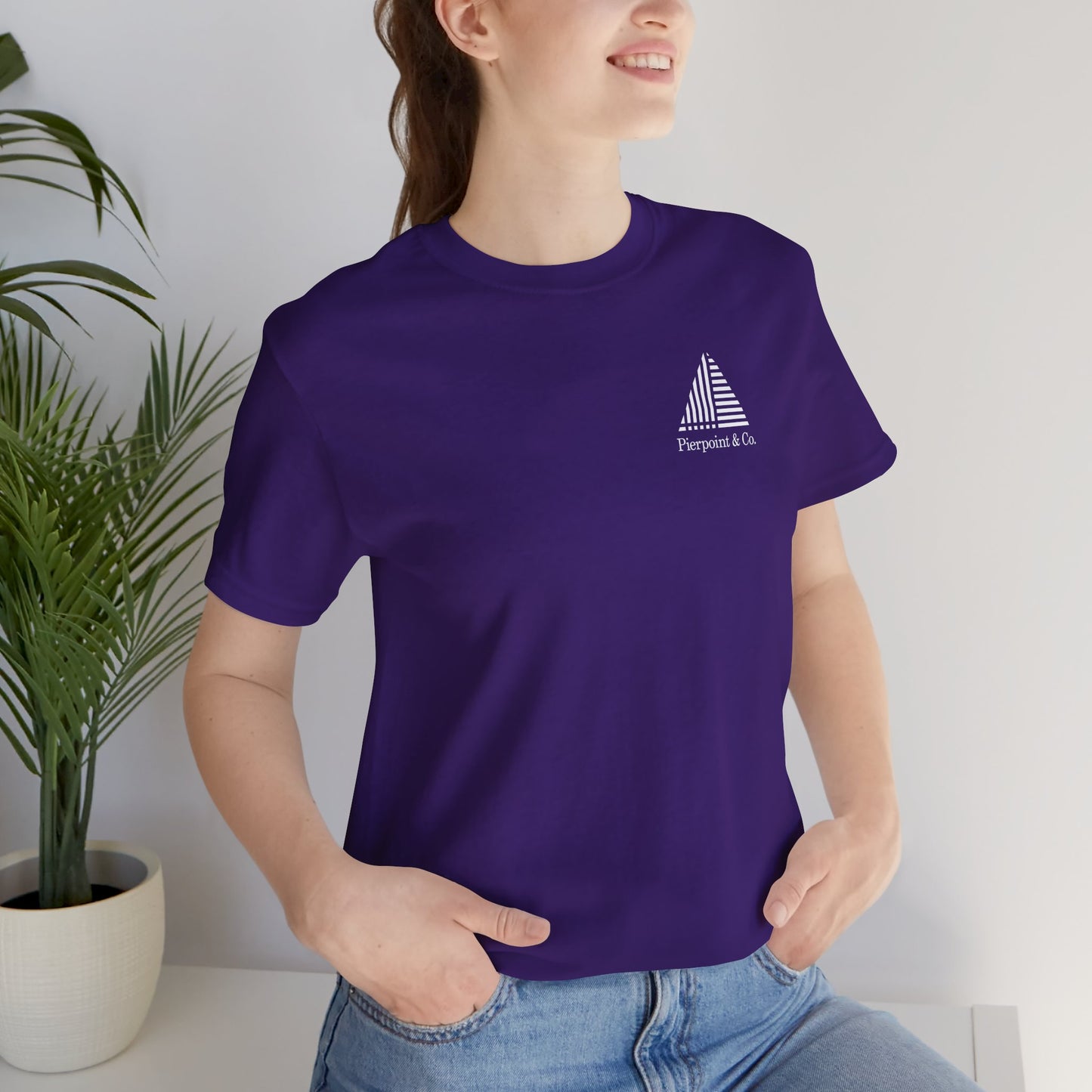 Woman wearing purple Pierpoint & Co. corner logo t-shirt inspired by HBO Industry TV series, soft Bella+Canvas cotton investment bank fan tee