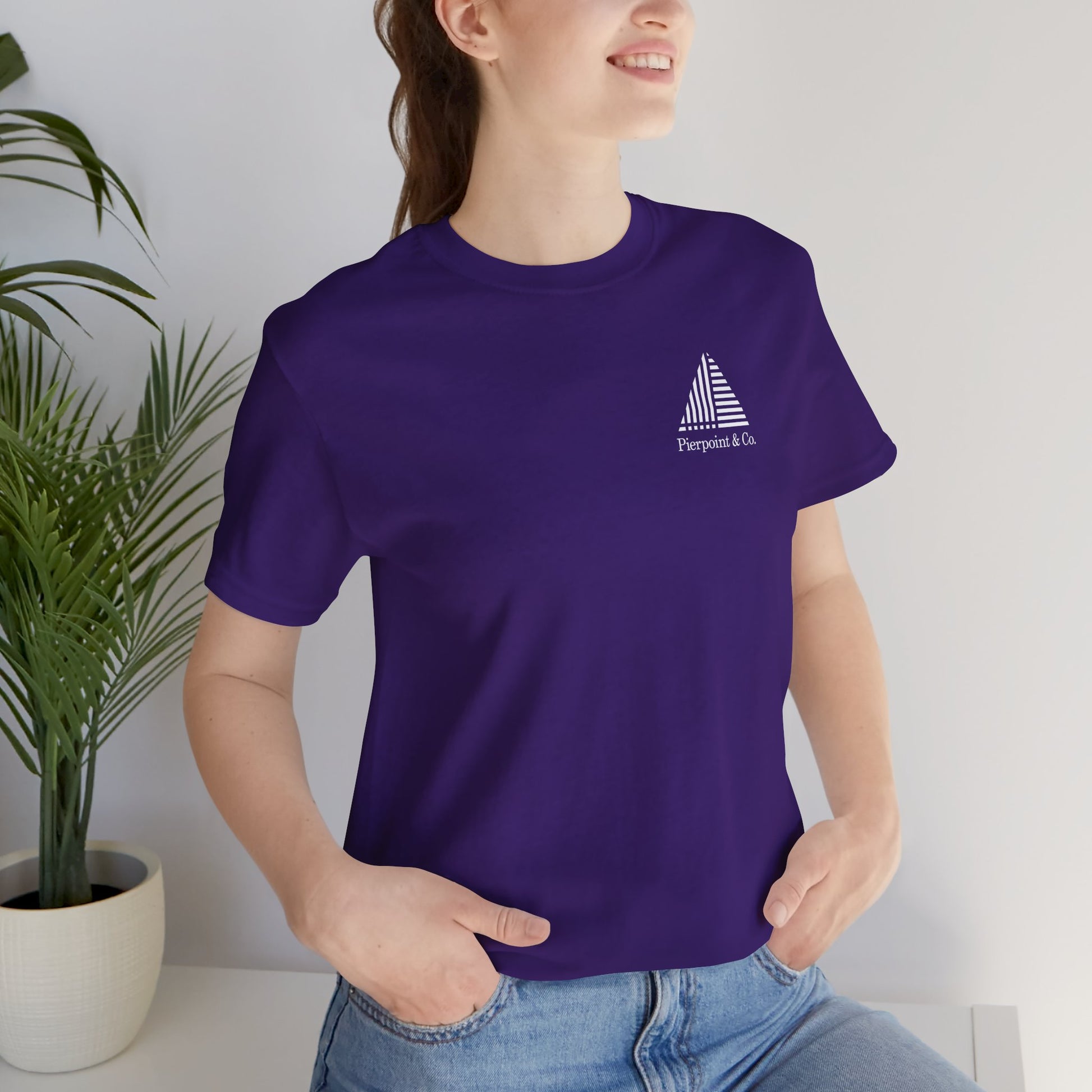 Woman wearing purple Pierpoint & Co. corner logo t-shirt inspired by HBO Industry TV series, soft Bella+Canvas cotton investment bank fan tee