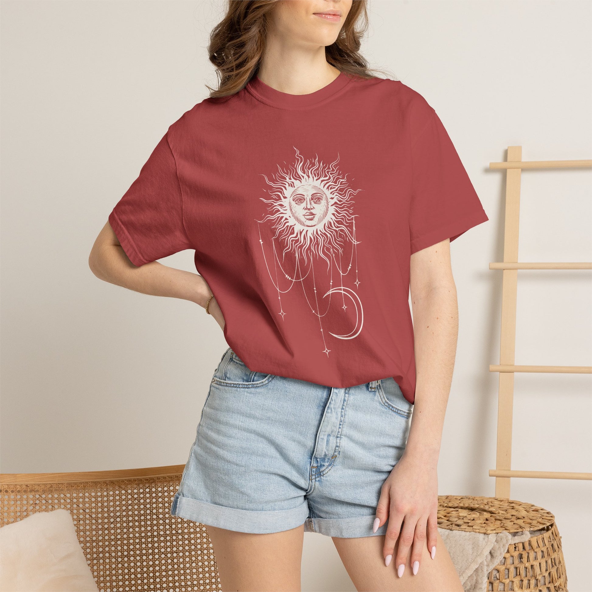 Woman wearing Crimson red Comfort Colors tee with a celestial sun and crescent moon design, worn by Patricia in Widow's Bay S1E8