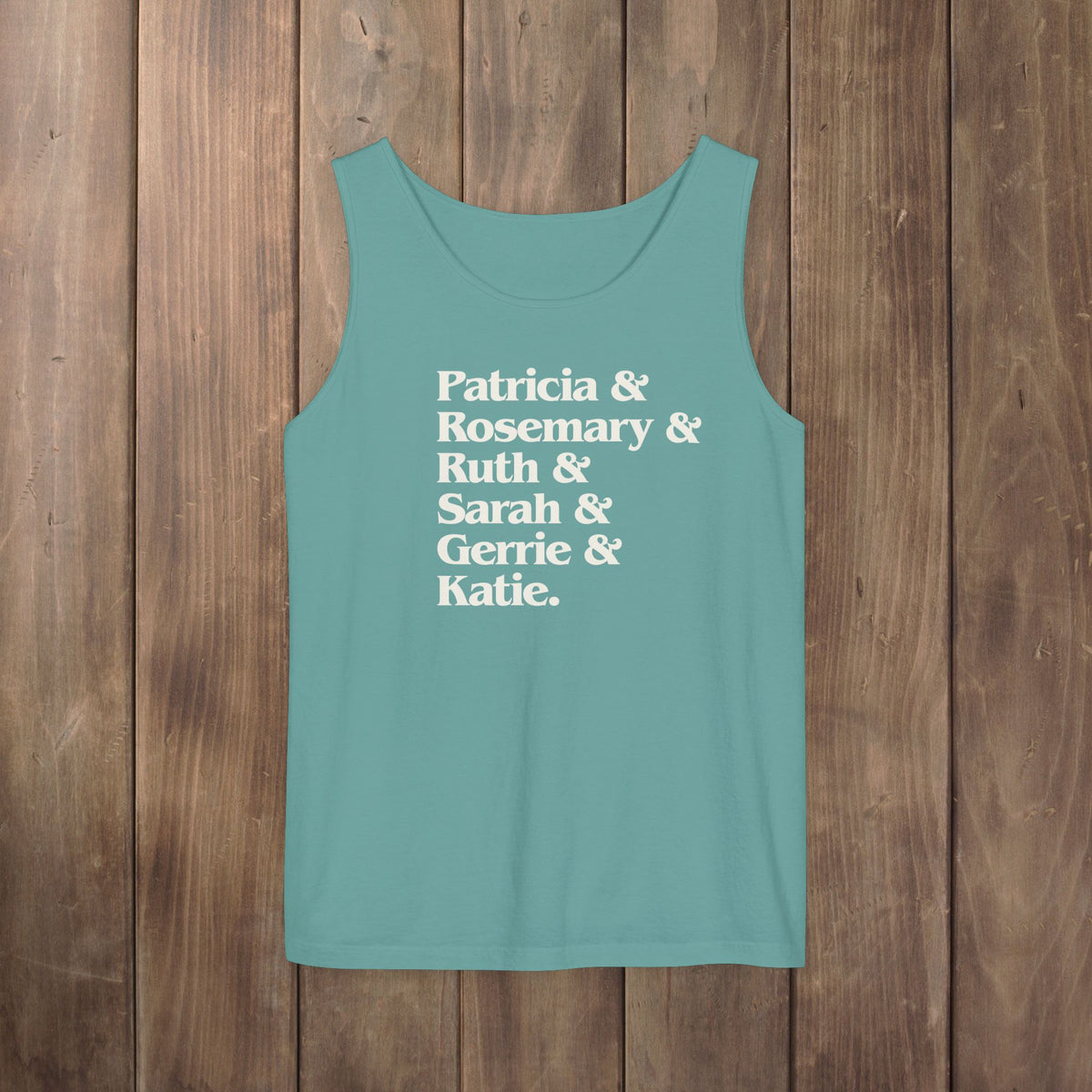 Seafoam green garment-dyed Comfort Colors tank top with stacked Women of Widow's Bay show names in ampersand list including Patricia, Ruth, Rosemary