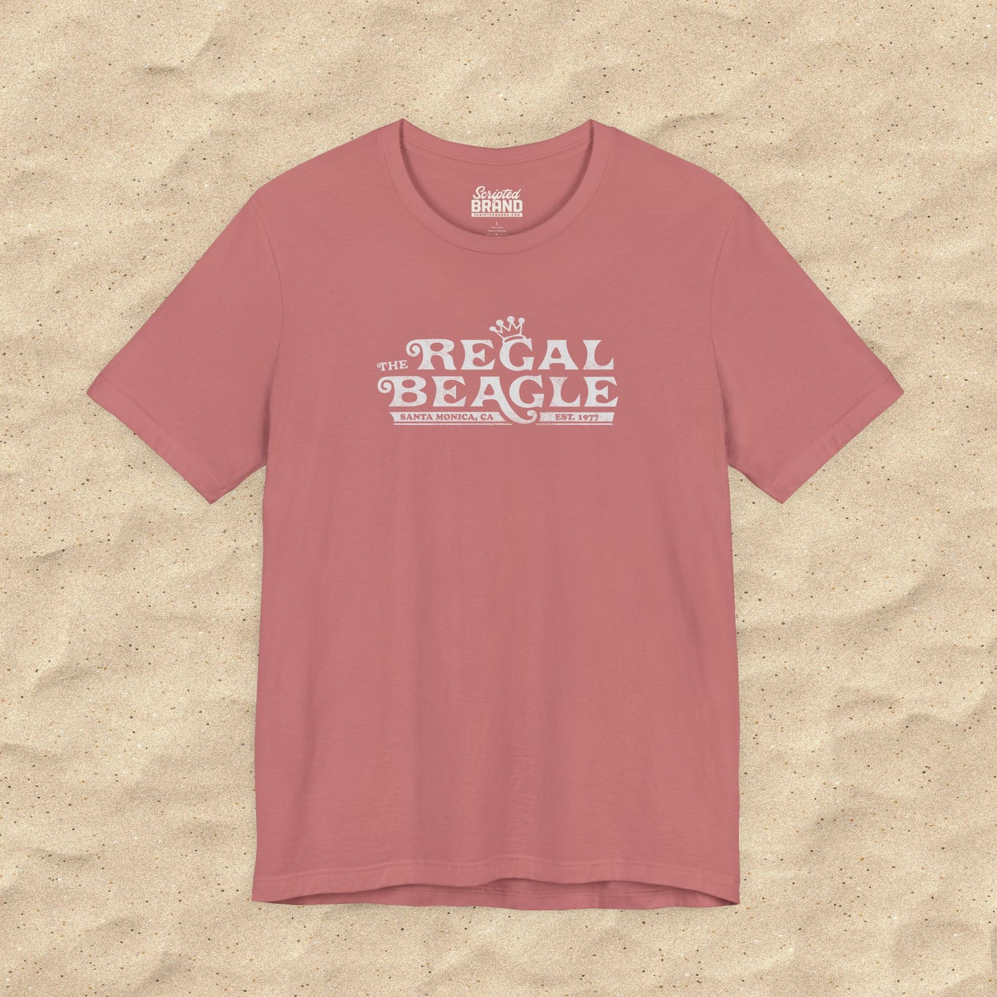 Mauve pink Bella+Canvas t-shirt with the Regal Beagle logo from the TV Show 'Threes Company' in a vintage distressed style.