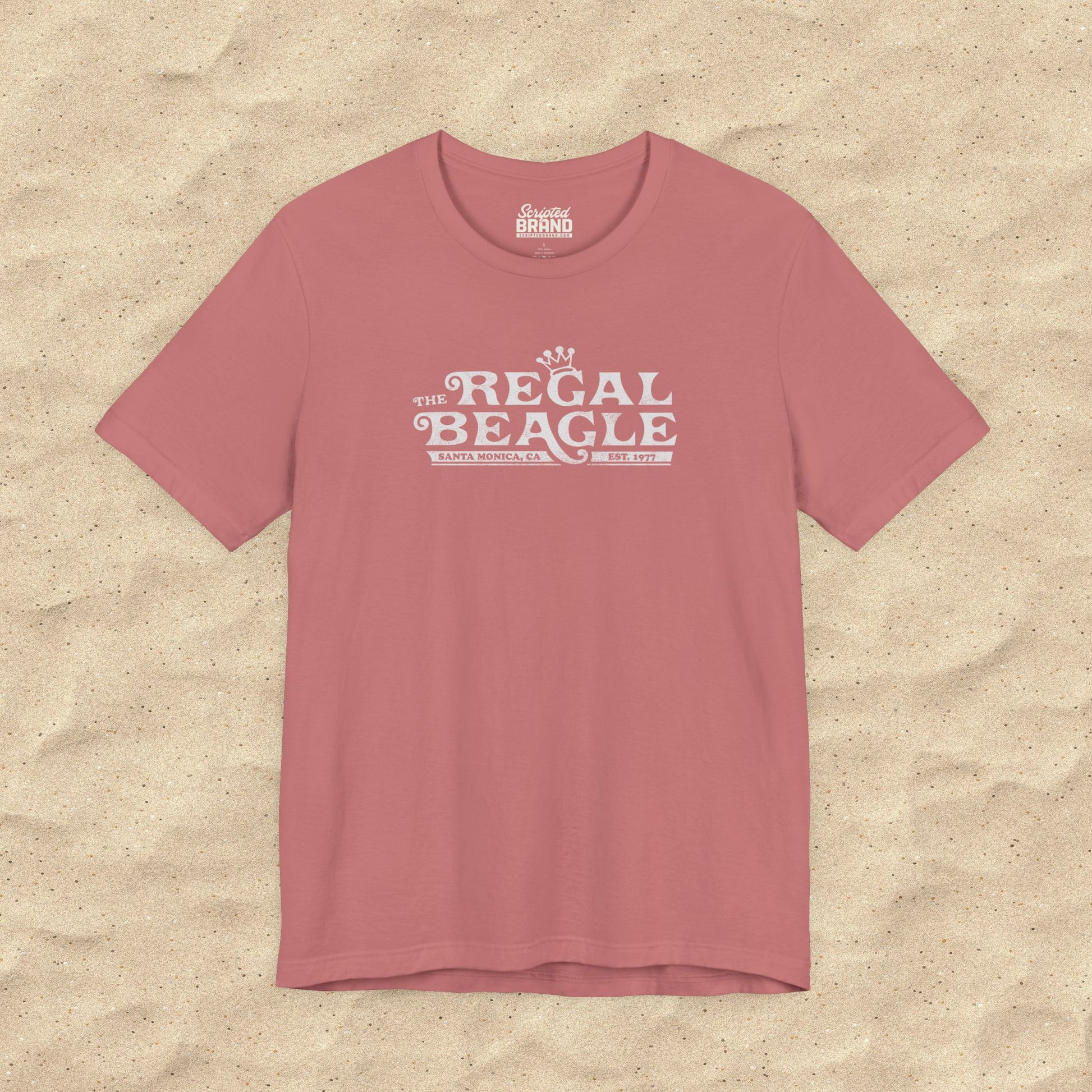 Mauve pink Bella+Canvas t-shirt with the Regal Beagle logo from the TV Show 'Threes Company' in a vintage distressed style.