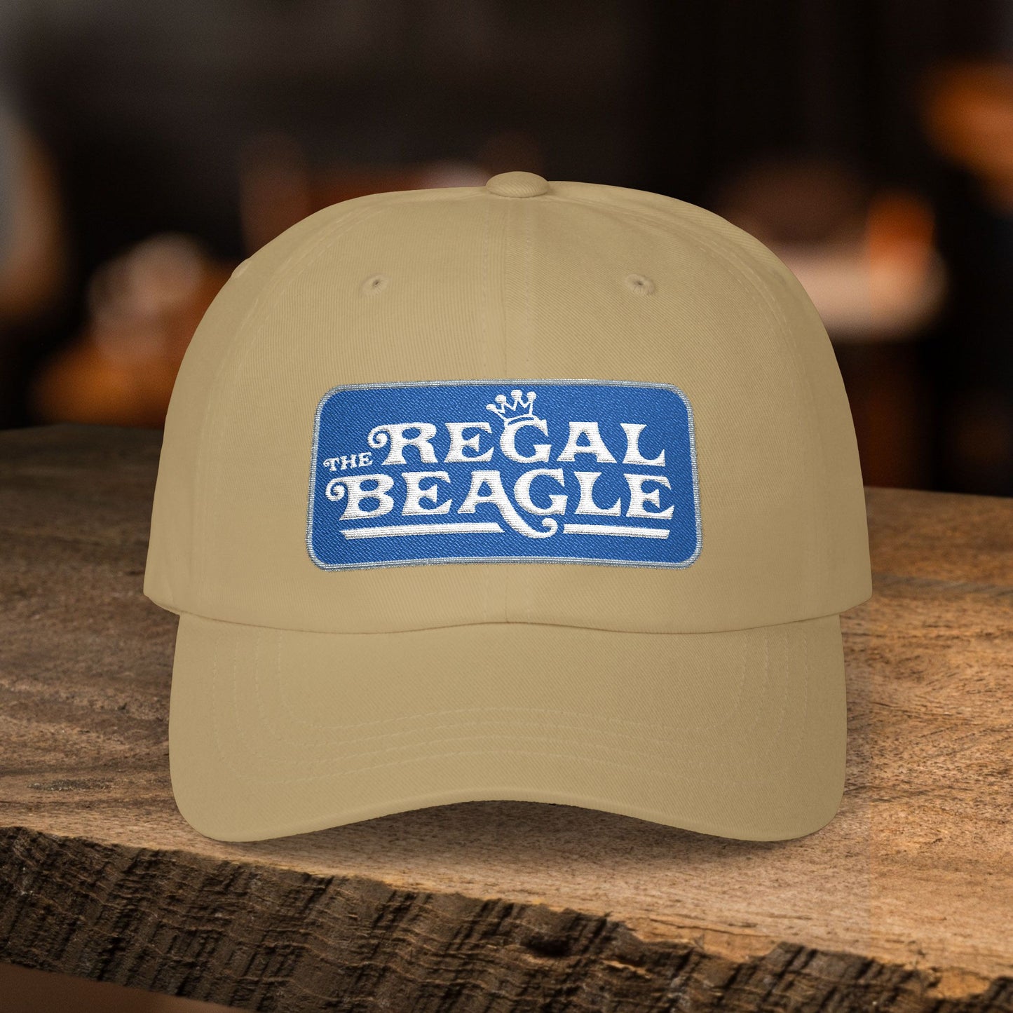 Khaki dad cap with embroidered Regal Beagle patch logo, Three's Company inspired fictional bar merch
