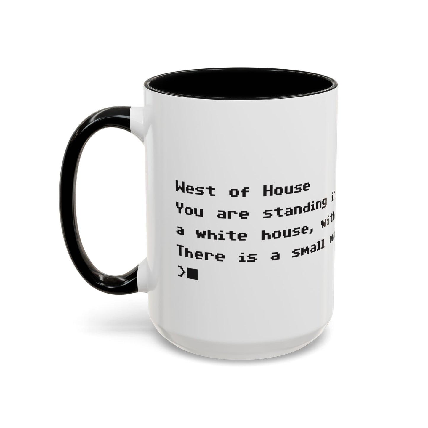 Left handle view of 15 oz White ceramic accent mug with black handle and interior, Zork “West of House” opening line text wrapped in black print