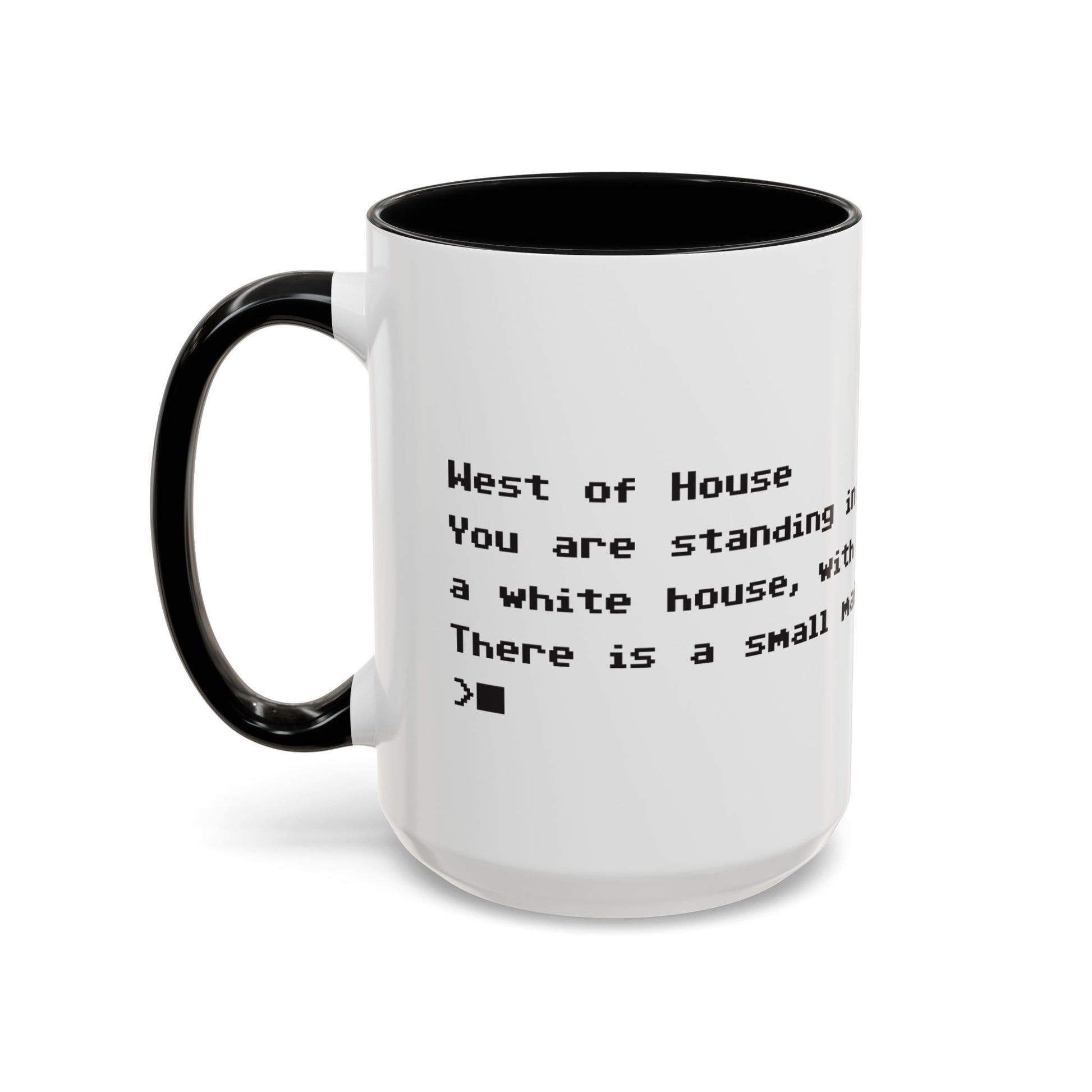 Left handle view of 15 oz White ceramic accent mug with black handle and interior, Zork “West of House” opening line text wrapped in black print