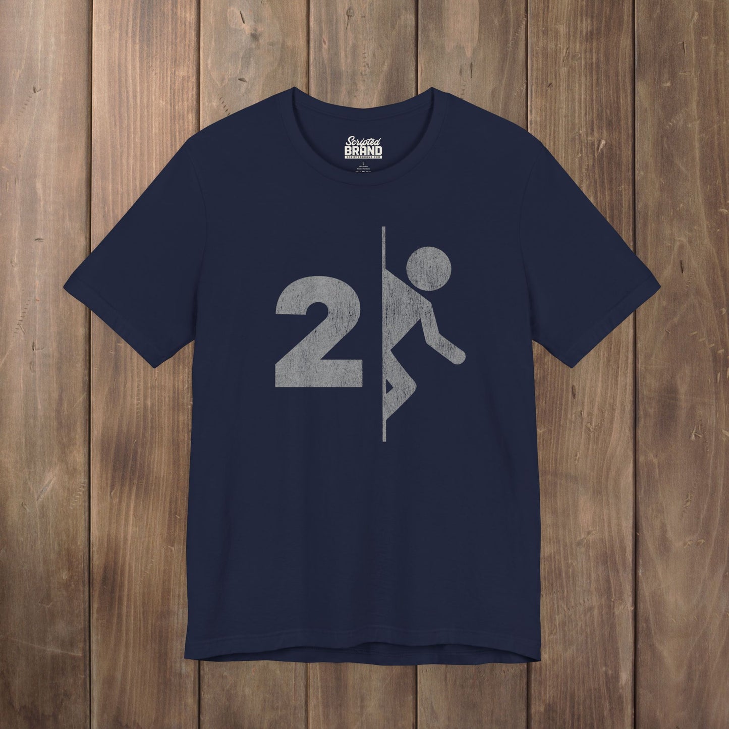 Navy blue tee with vintage distressed Portal 2 partial logo figure diving through a portal, aperture labs