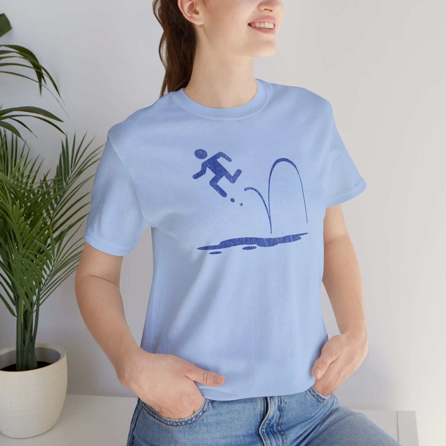 Woman wearing Light blue tee with blue vintage distressed Portal 2 Repulsion Gel icon of a figure bouncing off gel