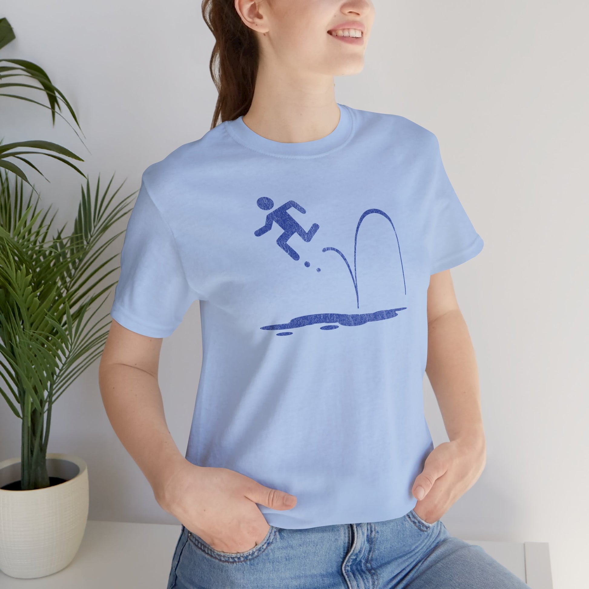 Woman wearing Light blue tee with blue vintage distressed Portal 2 Repulsion Gel icon of a figure bouncing off gel