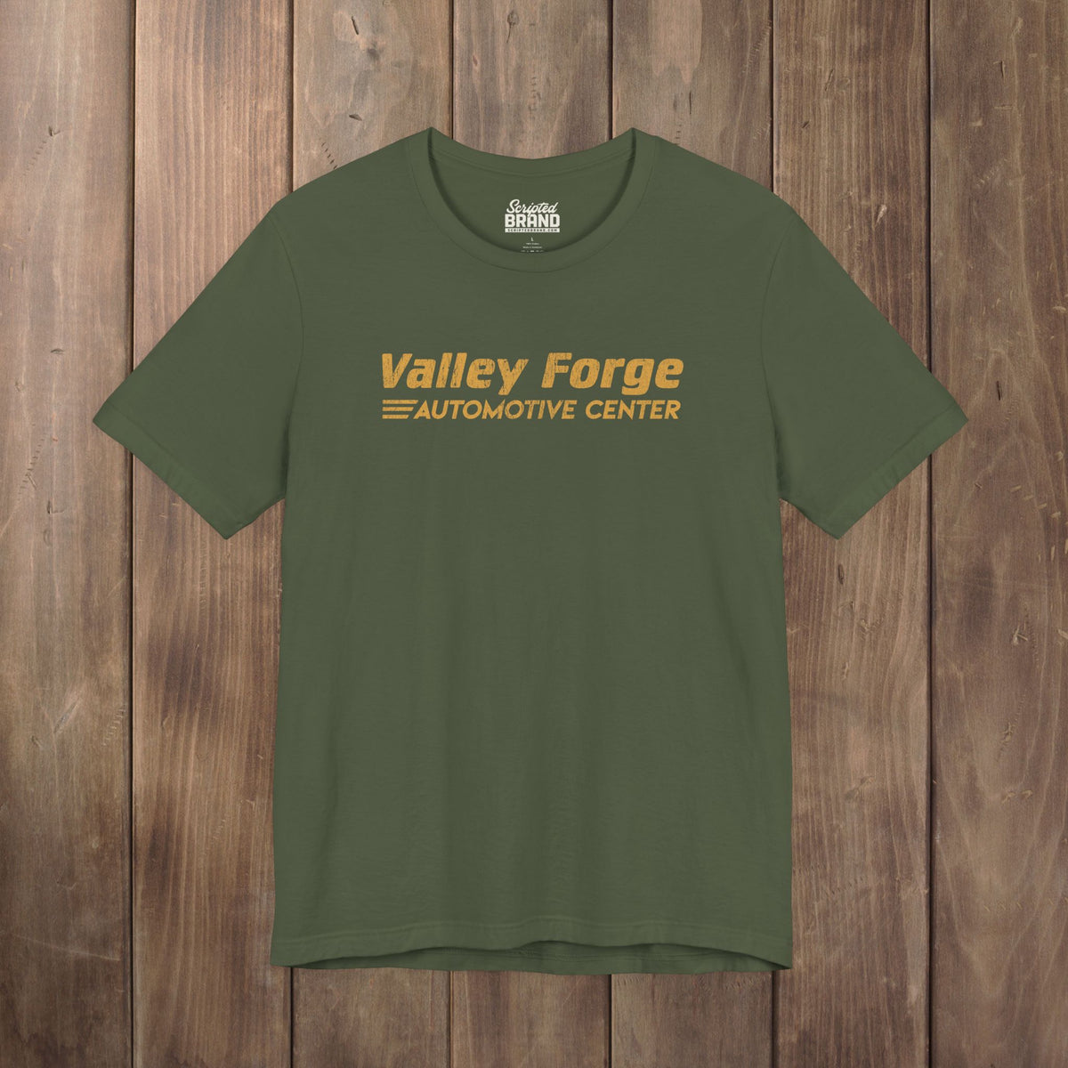 military green tee with vintage gold Valley Forge Automotive Center auto shop logo from comedian Shane Gillis Tires TV show