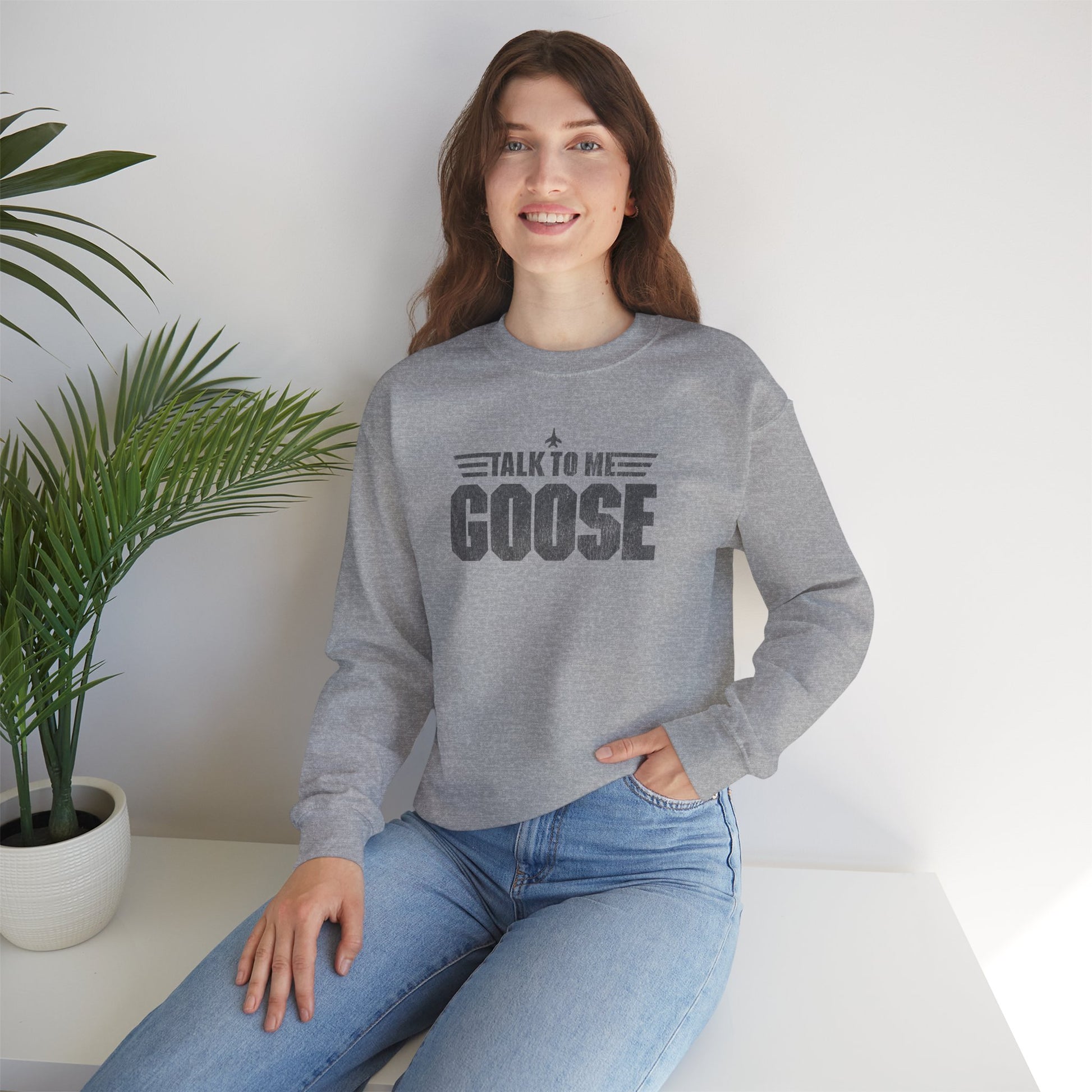 Female wearing athletic grey heather crewneck sweatshirt with distressed “Talk to Me Goose” graphic, inspired by the movie Top Gun.