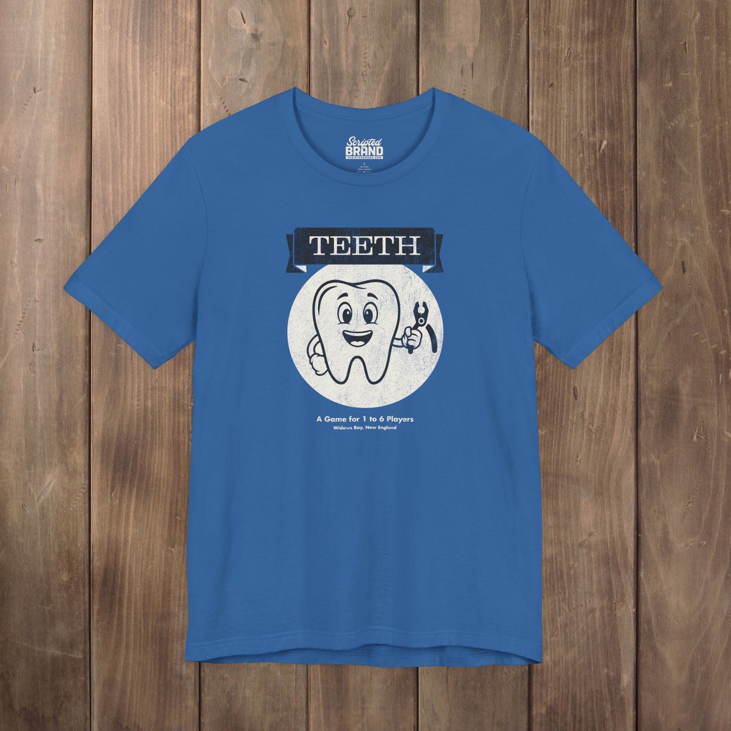 Columbia blue green Bella+Canvas tee with the vintage TEETH board game box cover from Widow's Bay, a smiling tooth holding pliers