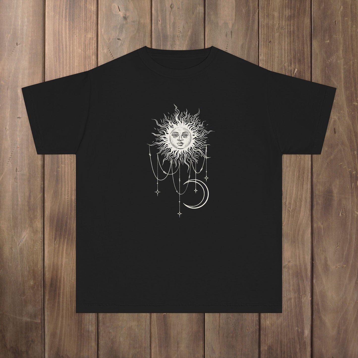 Front of black youth tee with Patricia boho celestial sun, stars, and crescent moon design from Widow's Bay