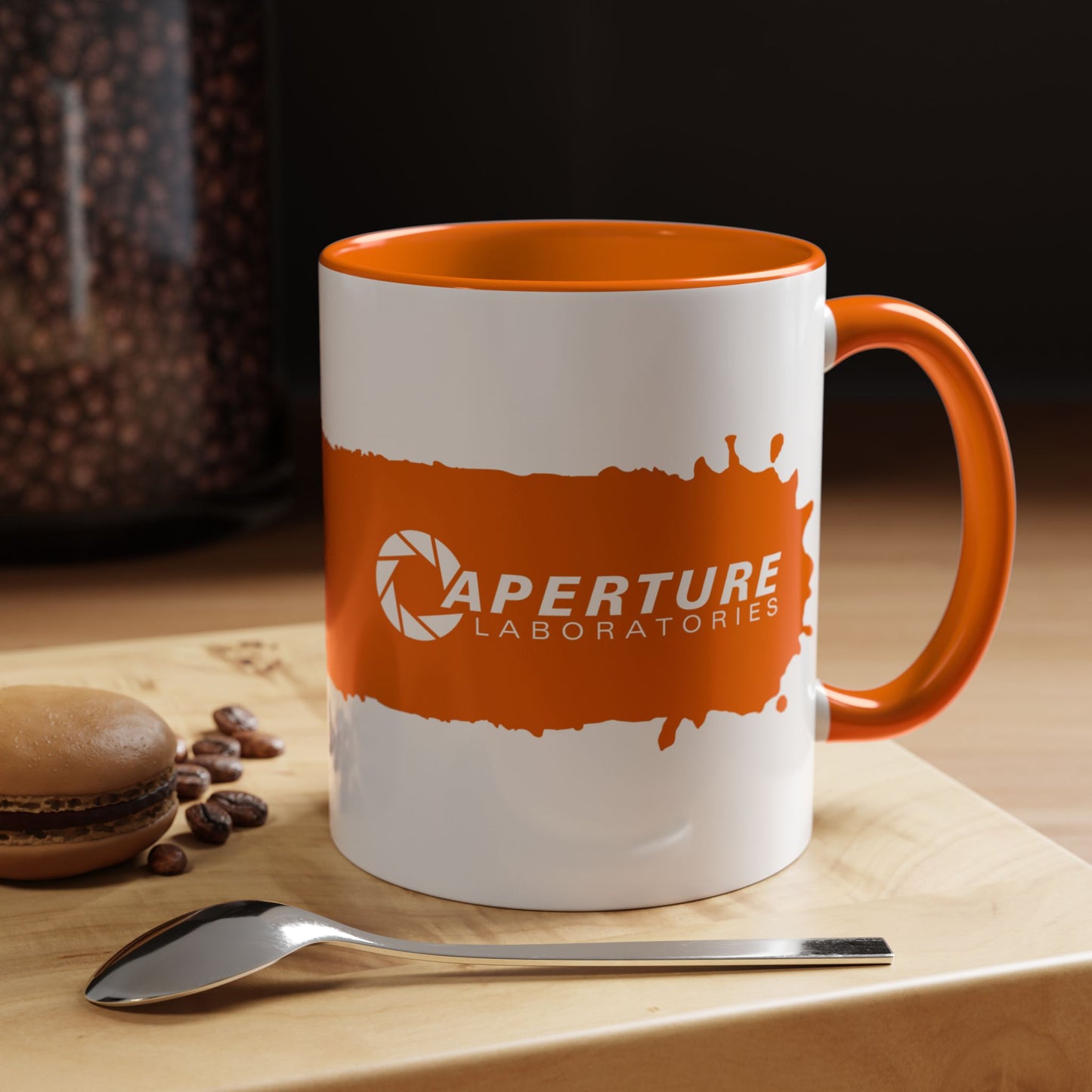 Kitchen view of 11oz Portal 2 Aperture Laboratories orange Propulsion Gel accent mug with orange handle, glossy ceramic.