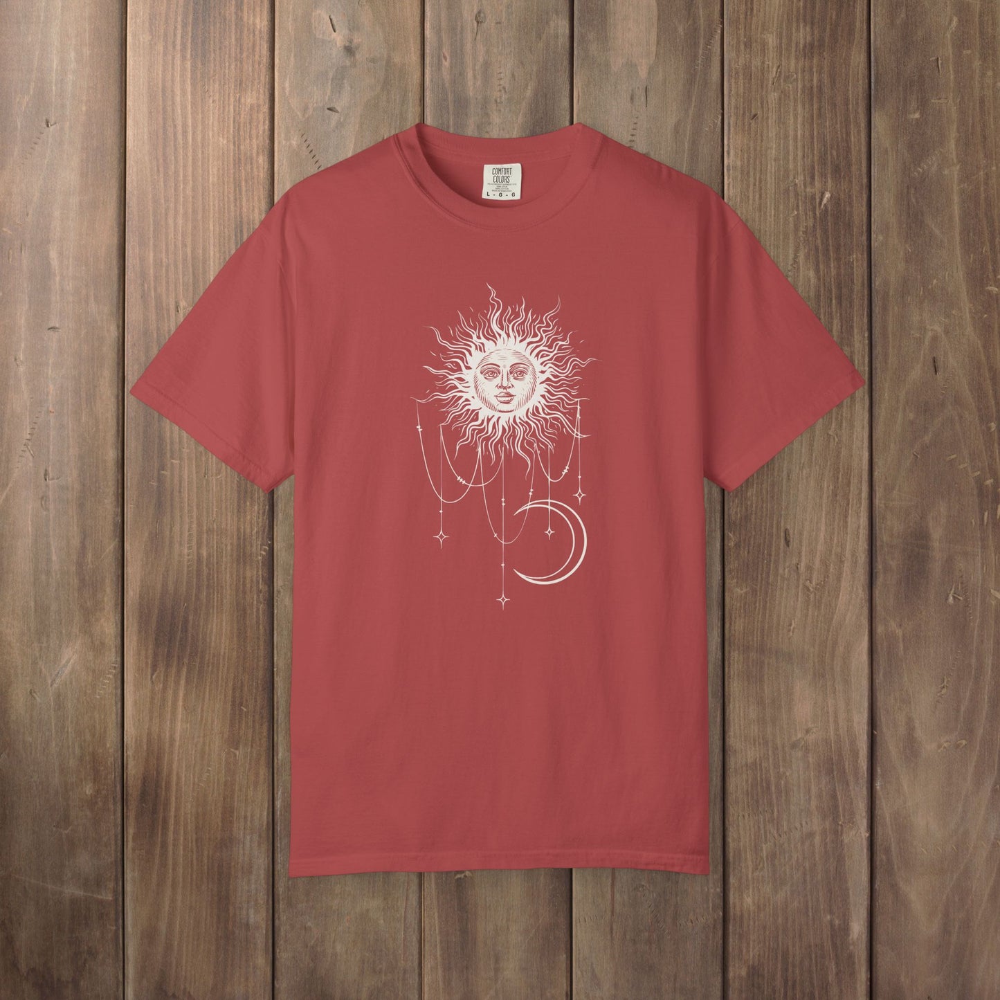 Crimson red Comfort Colors tee with a celestial sun and crescent moon design, worn by Patricia in Widow's Bay S1E8