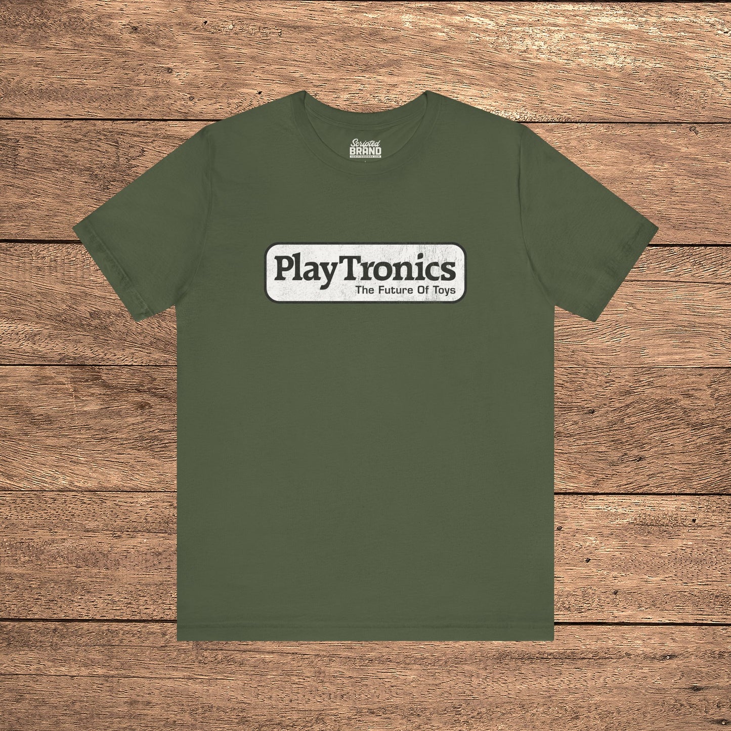 Military green PlayTronics Sneakers movie logo t-shirt on Bella+Canvas 3001, vintage distressed print, shown on wood floor.