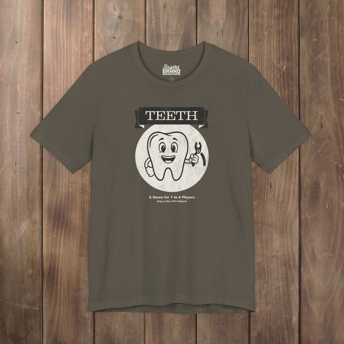 Army green Bella+Canvas tee with the vintage TEETH board game box cover from Widow's Bay, a smiling tooth holding pliers