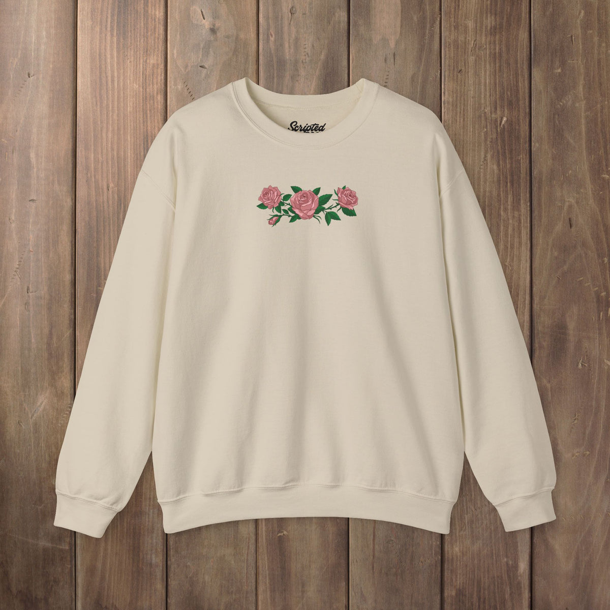 Sand beige tan crewneck sweatshirt with three pink roses and green leaves printed across the chest, inspired by Ruth of Widow's Bay