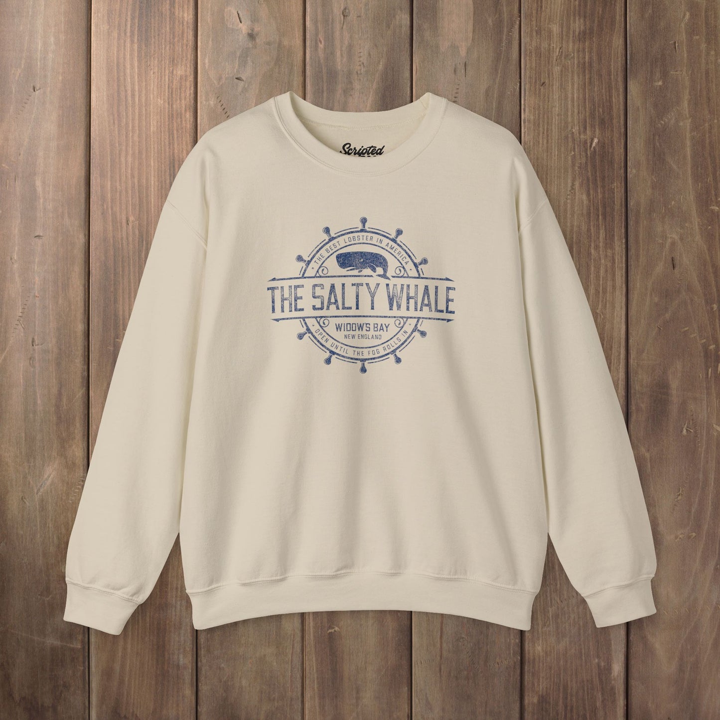Sand Gildan crewneck sweatshirt with the distressed Salty Whale maritime crest logo from TV show Widow's Bay