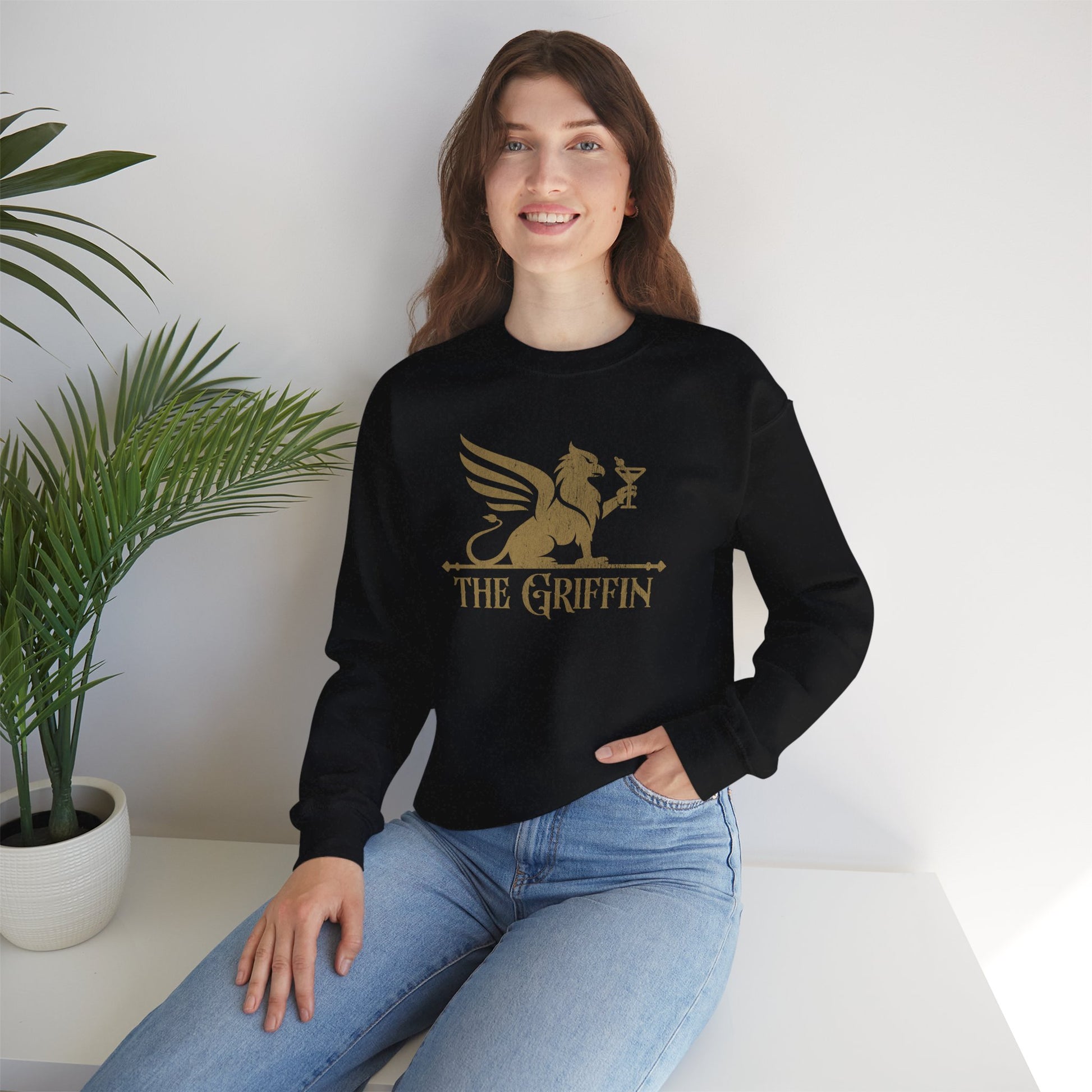 Woman wearing black crewneck sweatshirt with vintage distressed The Griffin Bar logo graphic inspired by New Girl
