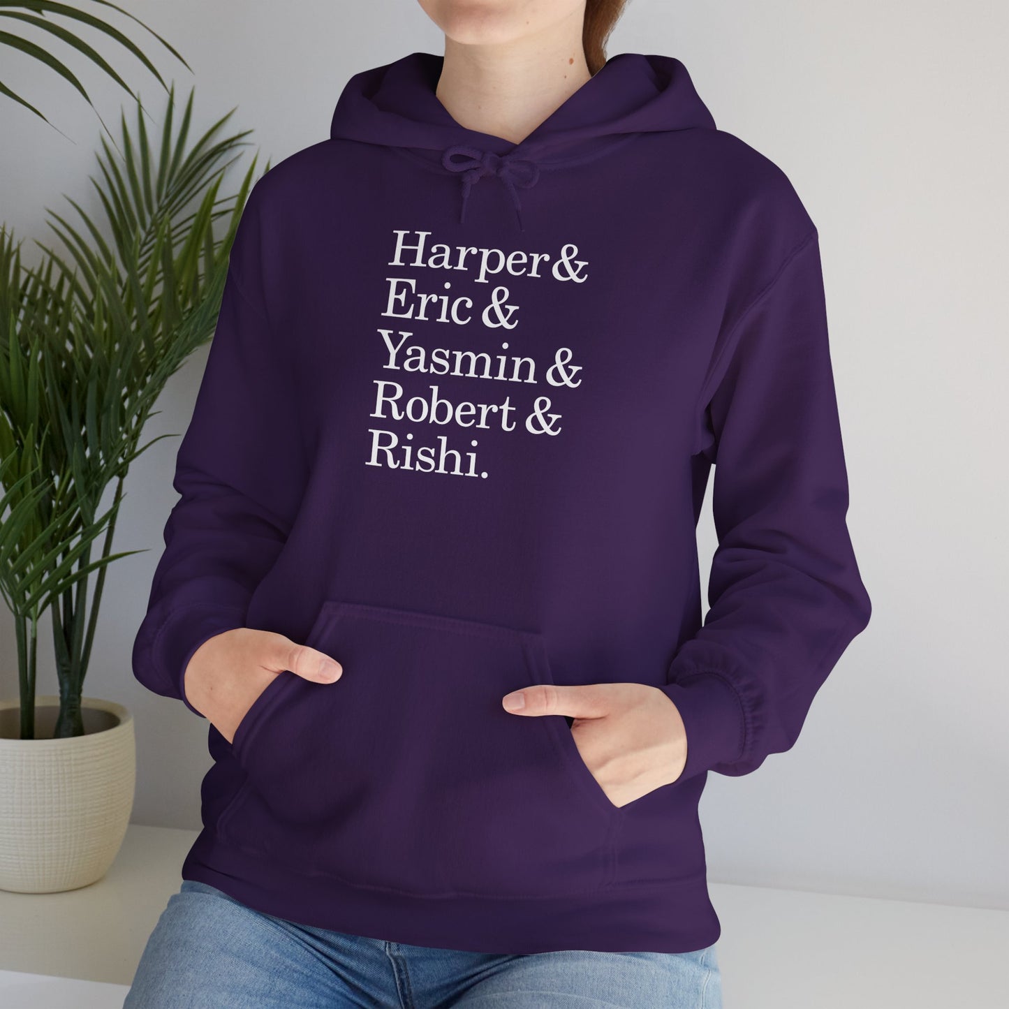 Woman wearing purple hoodie with names Harper, Eric, Yasmin, Robert & Rishi in Pierpoint & Co. font, inspired by TV show Industry.