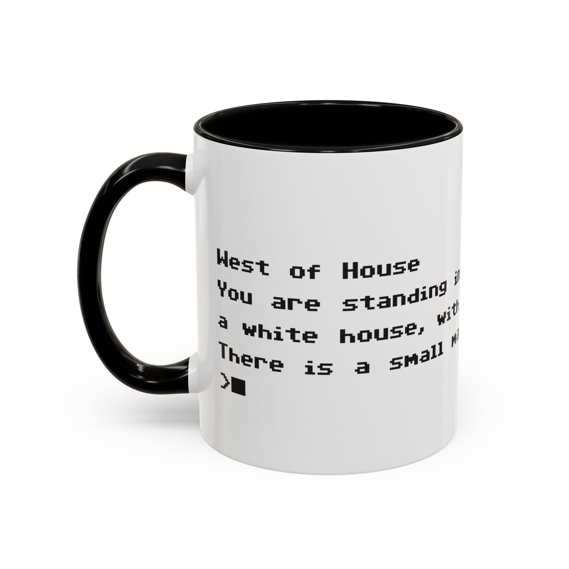 Left handle view of 11 oz White ceramic accent mug with black handle and interior, Zork “West of House” opening line text wrapped in black print