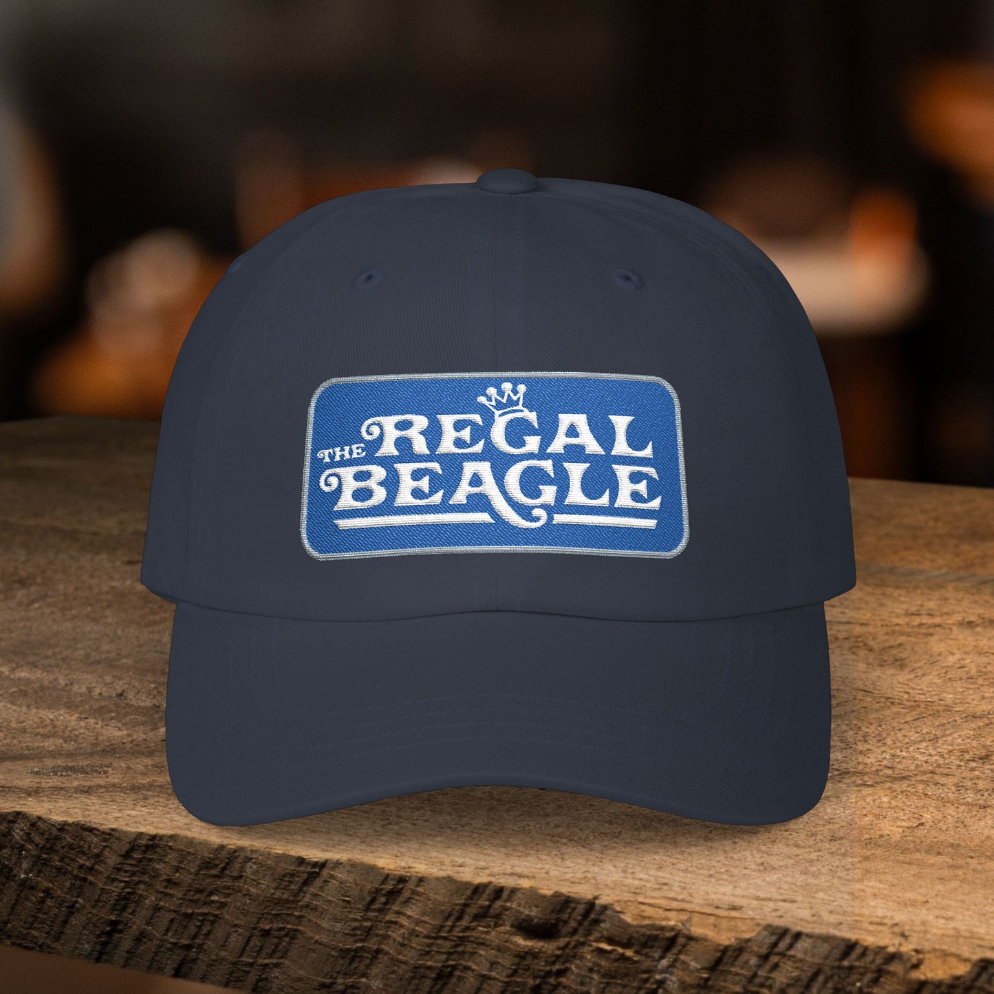 Navy blue dad cap with embroidered Regal Beagle patch logo, Three's Company inspired fictional bar merch
