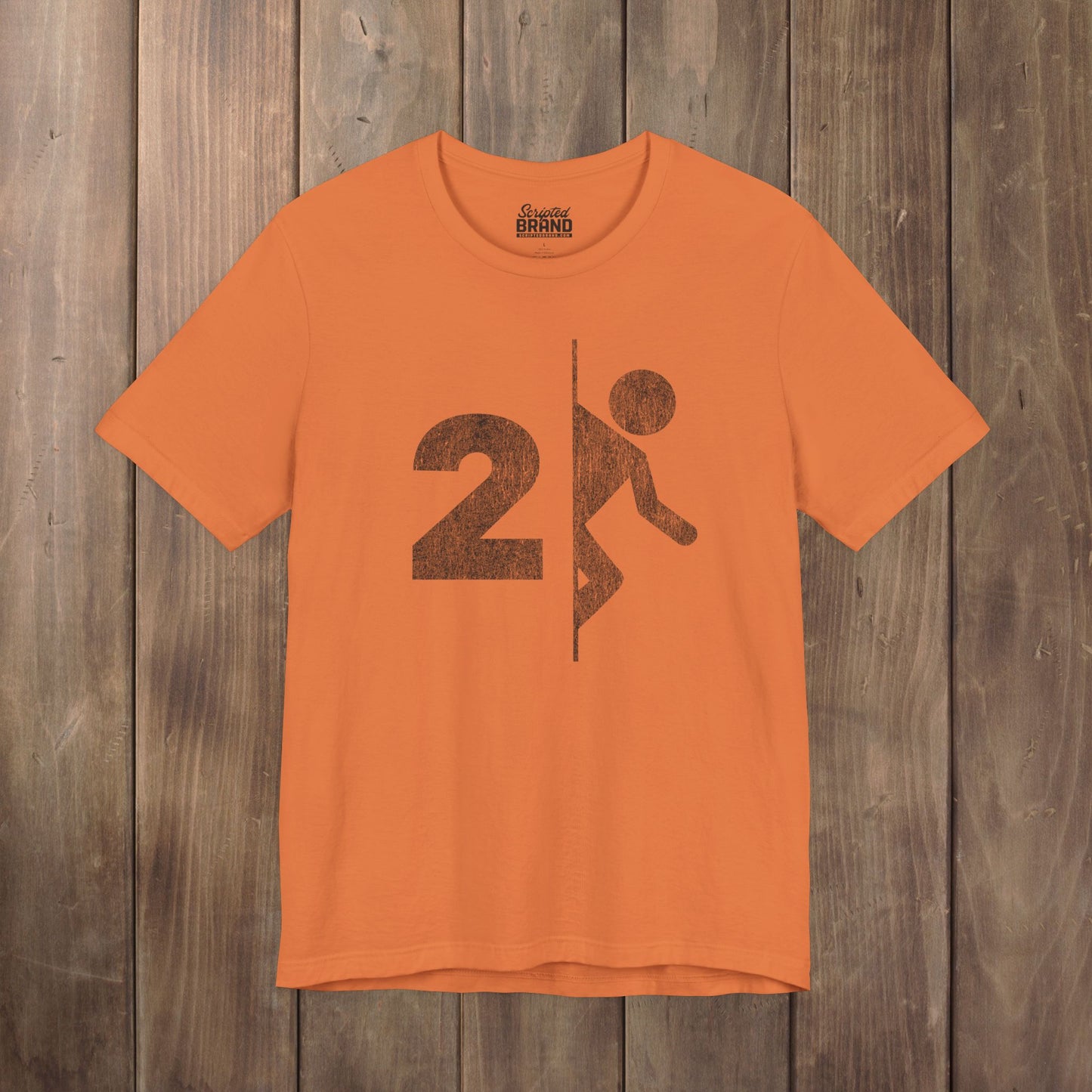 Orange tee with vintage distressed Portal 2 partial logo figure diving through a portal, aperture labs