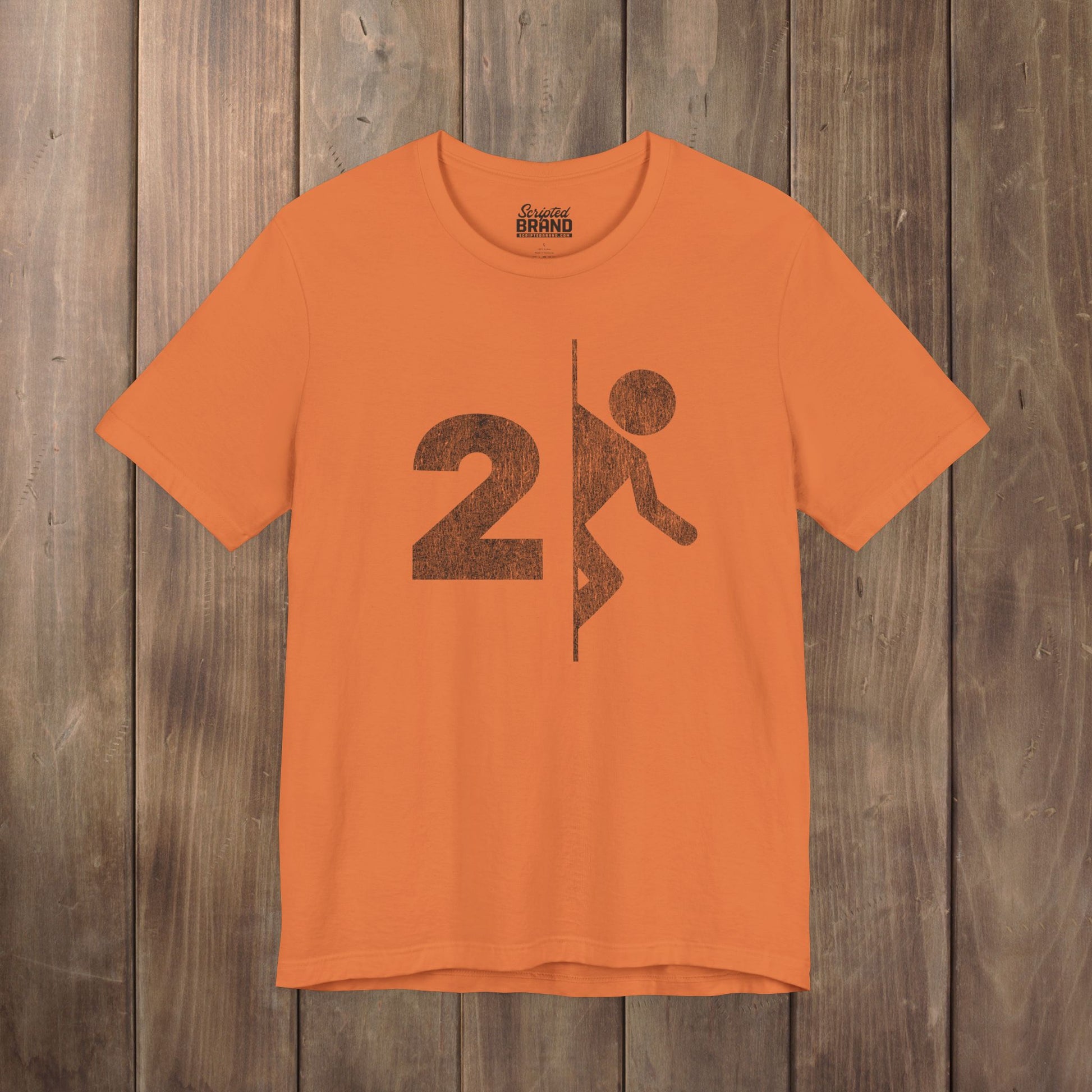 Orange tee with vintage distressed Portal 2 partial logo figure diving through a portal, aperture labs