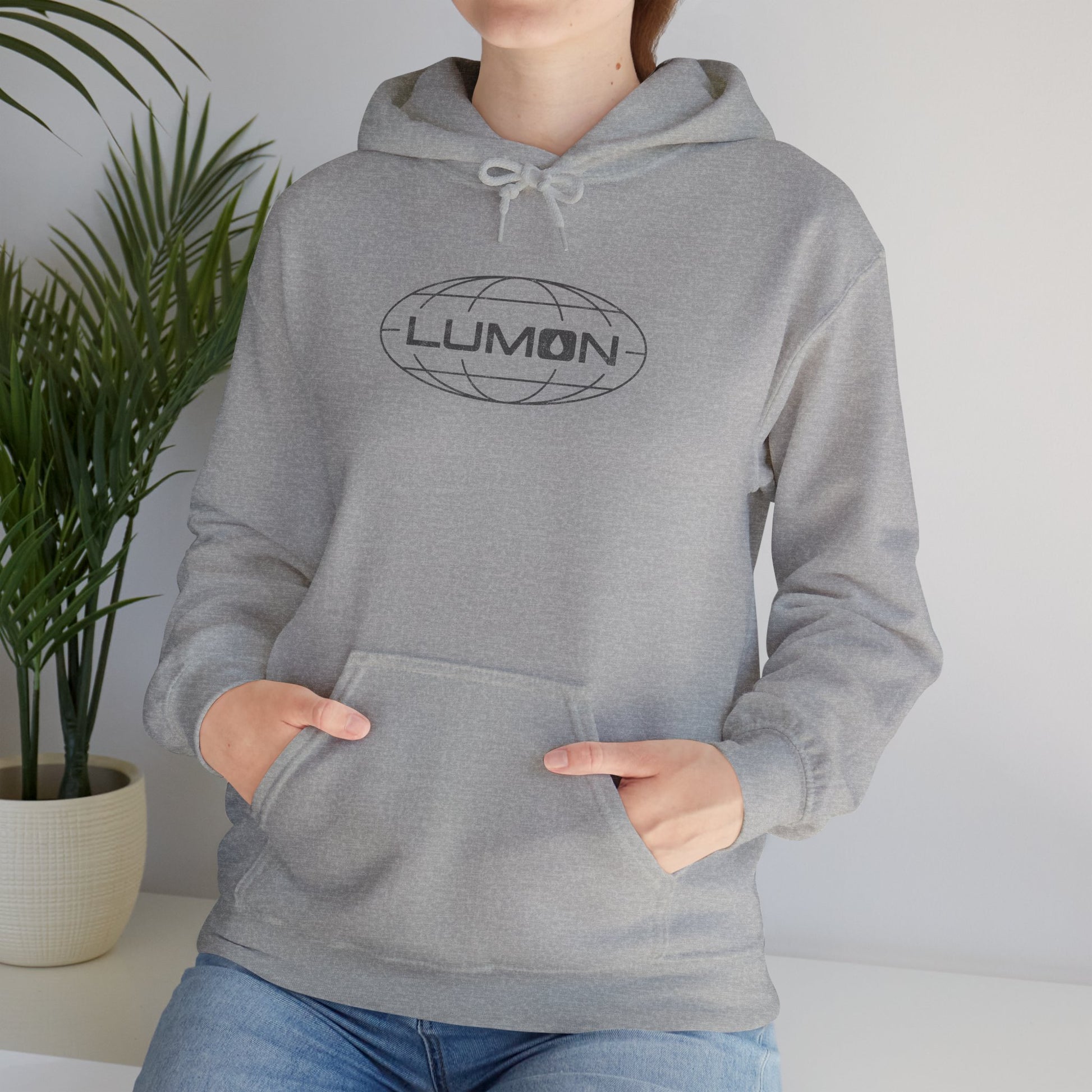 Woman model wearing a Sport Heather Gray Blue colored Soft Unisex Heavy Blend Hooded Sweatshirt featuring the fictional Lumon Industries logo from the Apple TV show Severance.