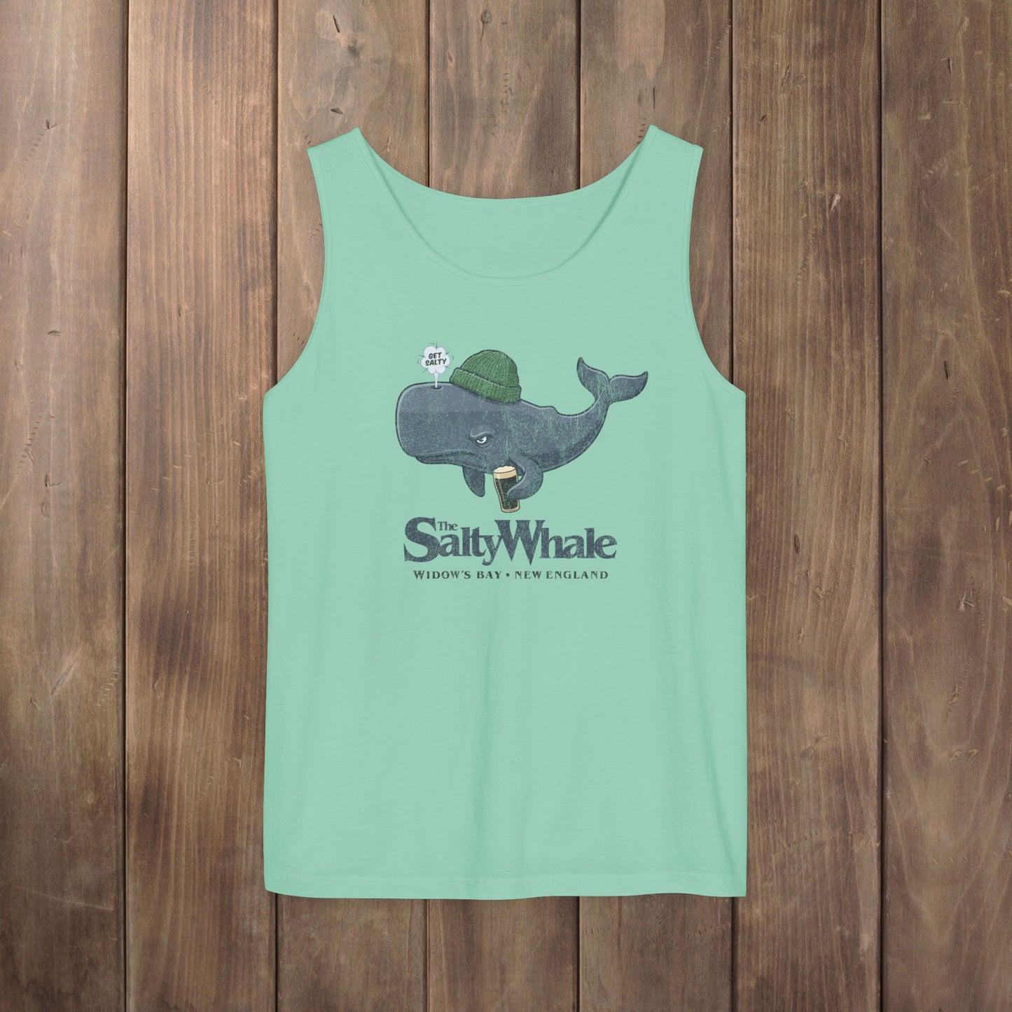 Light green Comfort Colors tank with the Salty Whale logo from Widow's Bay, a beanie-wearing cartoon whale drinking dark beer