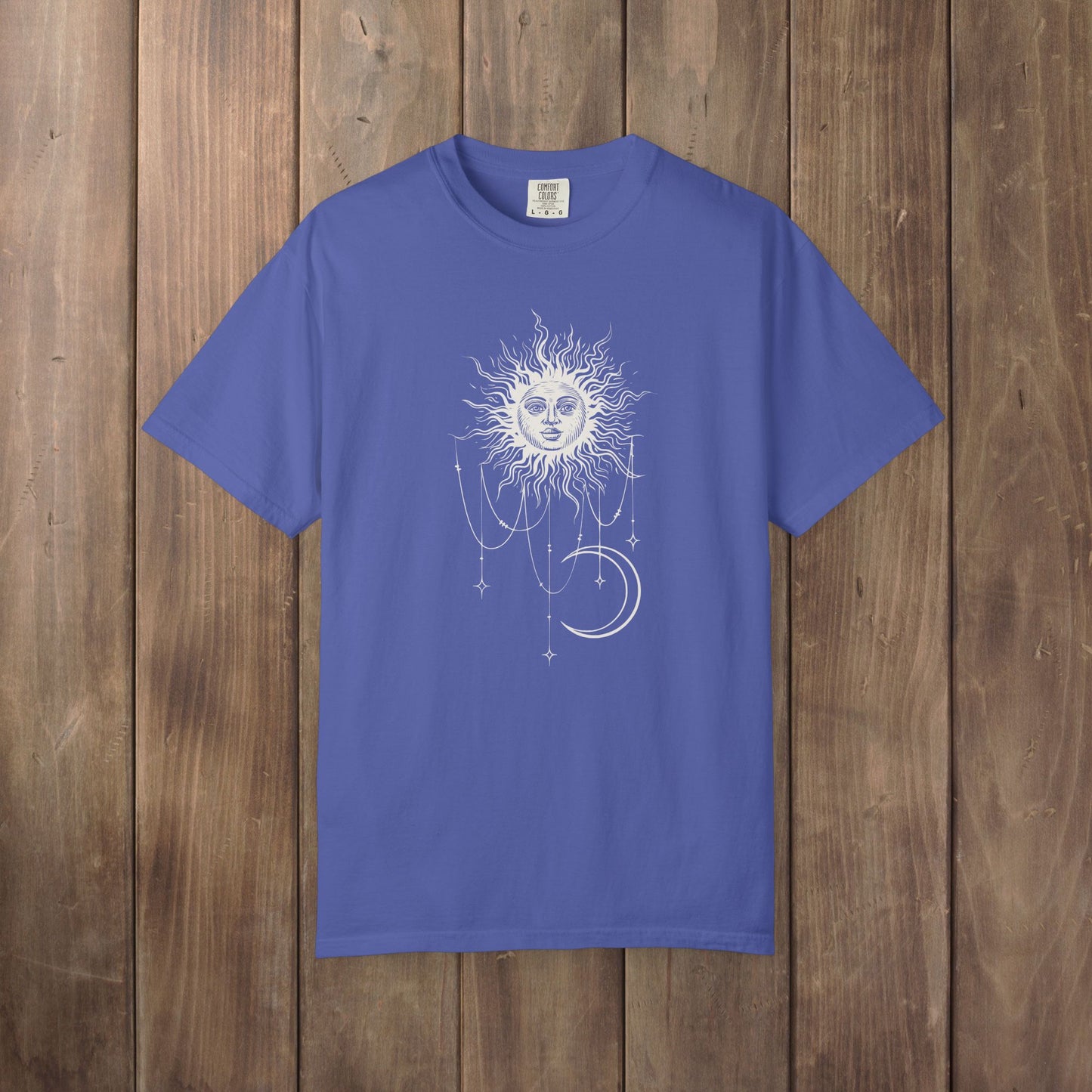 Periwinkle blue Comfort Colors tee with a celestial sun and crescent moon design, worn by Patricia in Widow's Bay S1E8