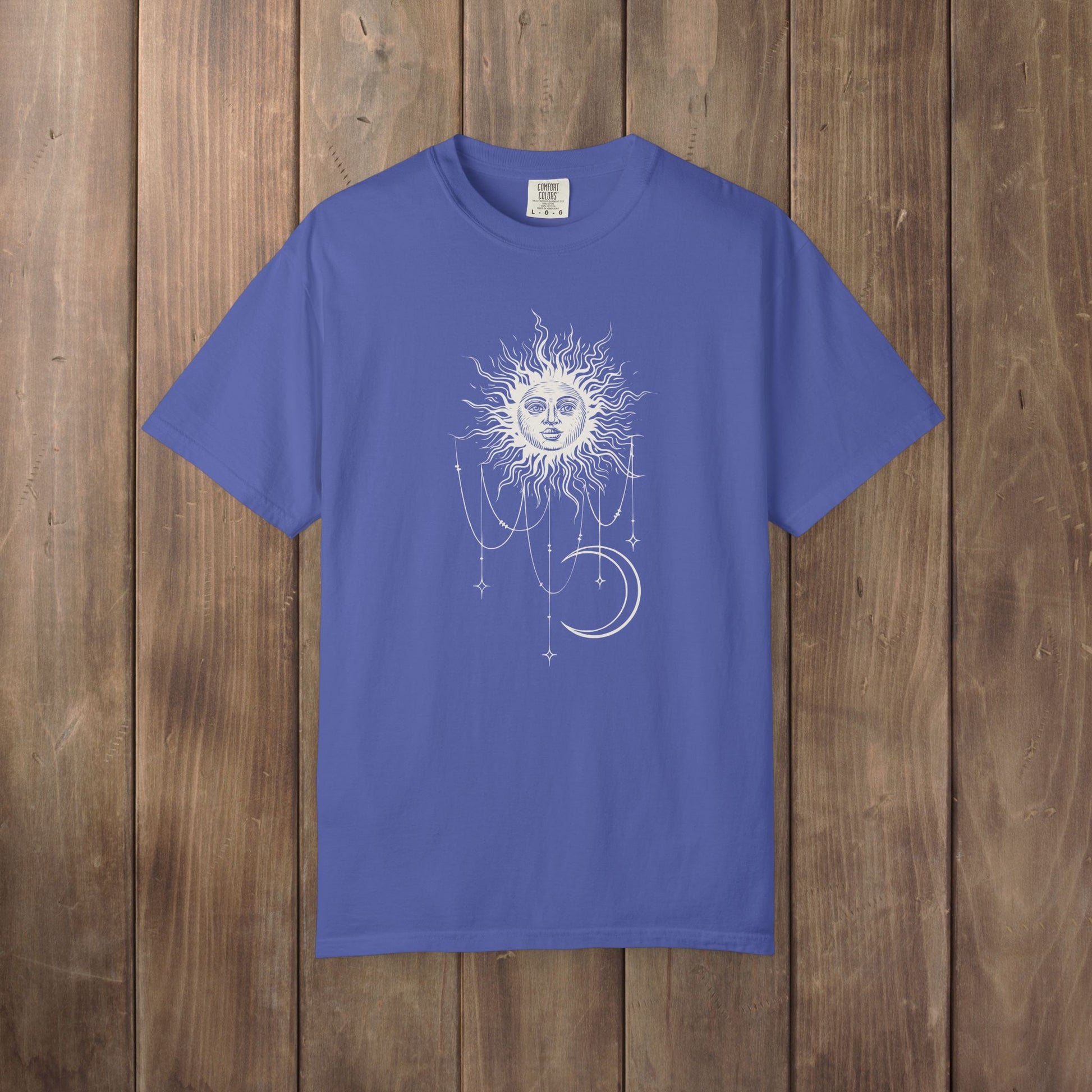 Periwinkle blue Comfort Colors tee with a celestial sun and crescent moon design, worn by Patricia in Widow's Bay S1E8