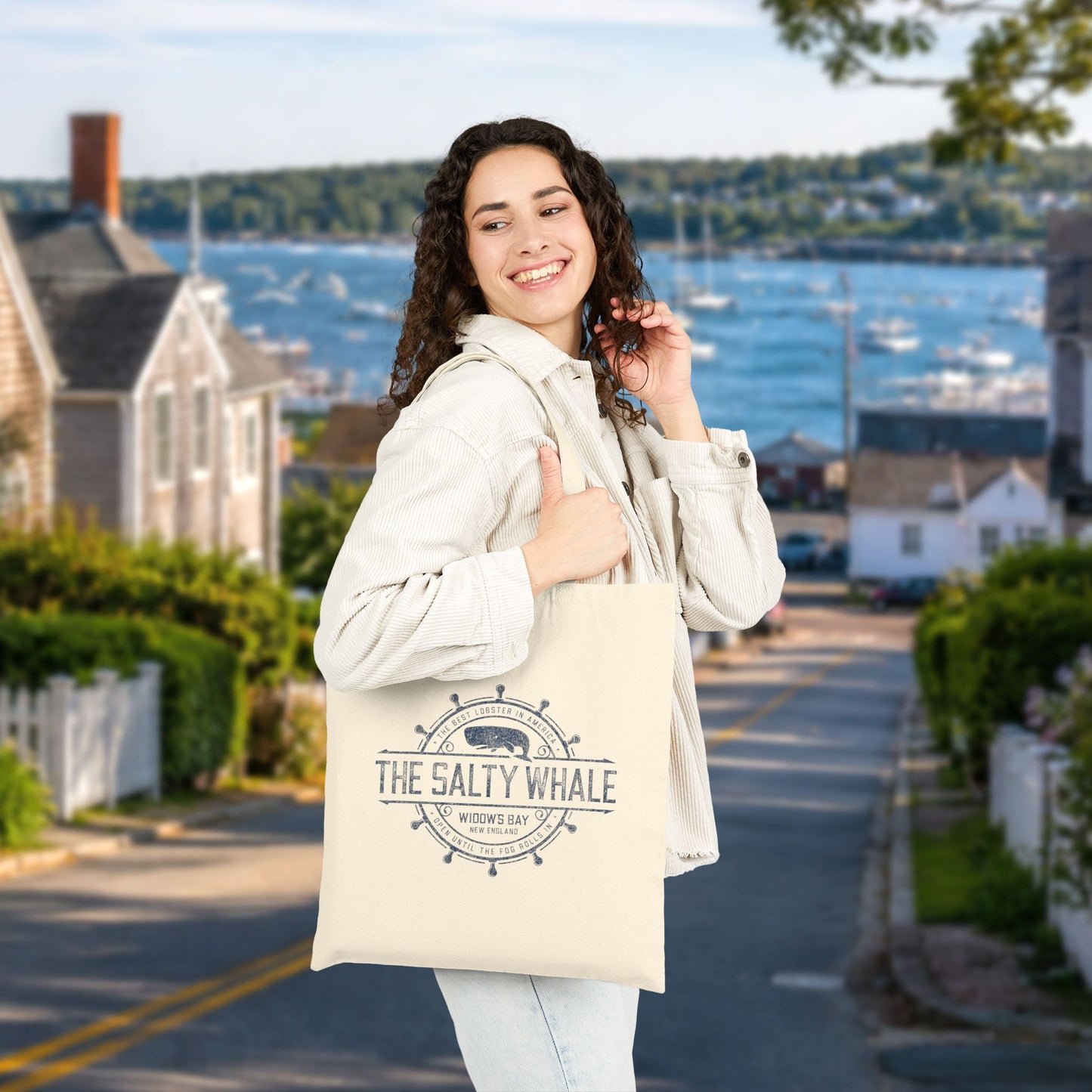 Person carrying natural canvas tote bag with vintage The Salty Whale, Widow's Bay TV show nautical grocery shopping