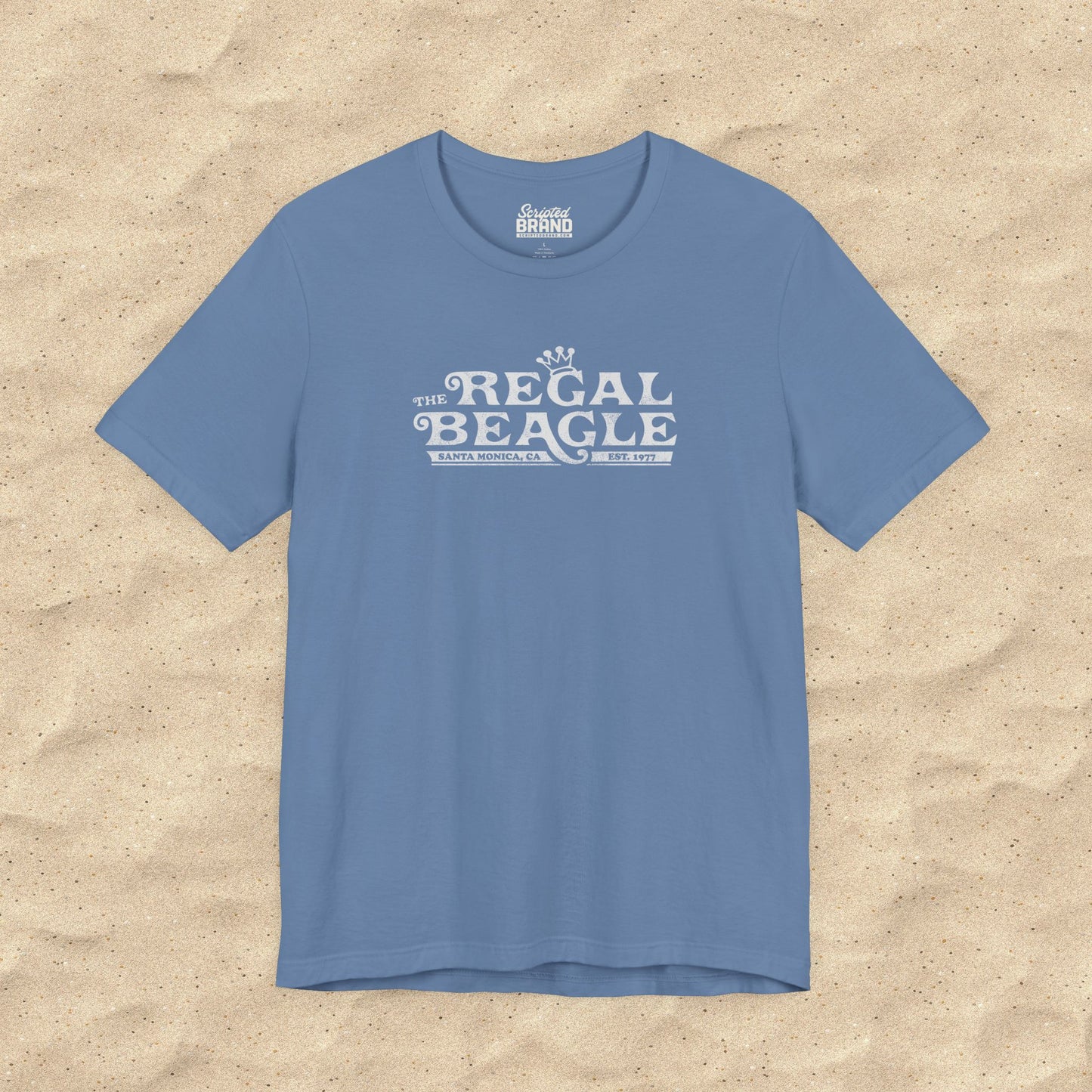 Lavender Blue Bella+Canvas t-shirt with the Regal Beagle logo from the TV Show 'Threes Company' in a vintage distressed style.