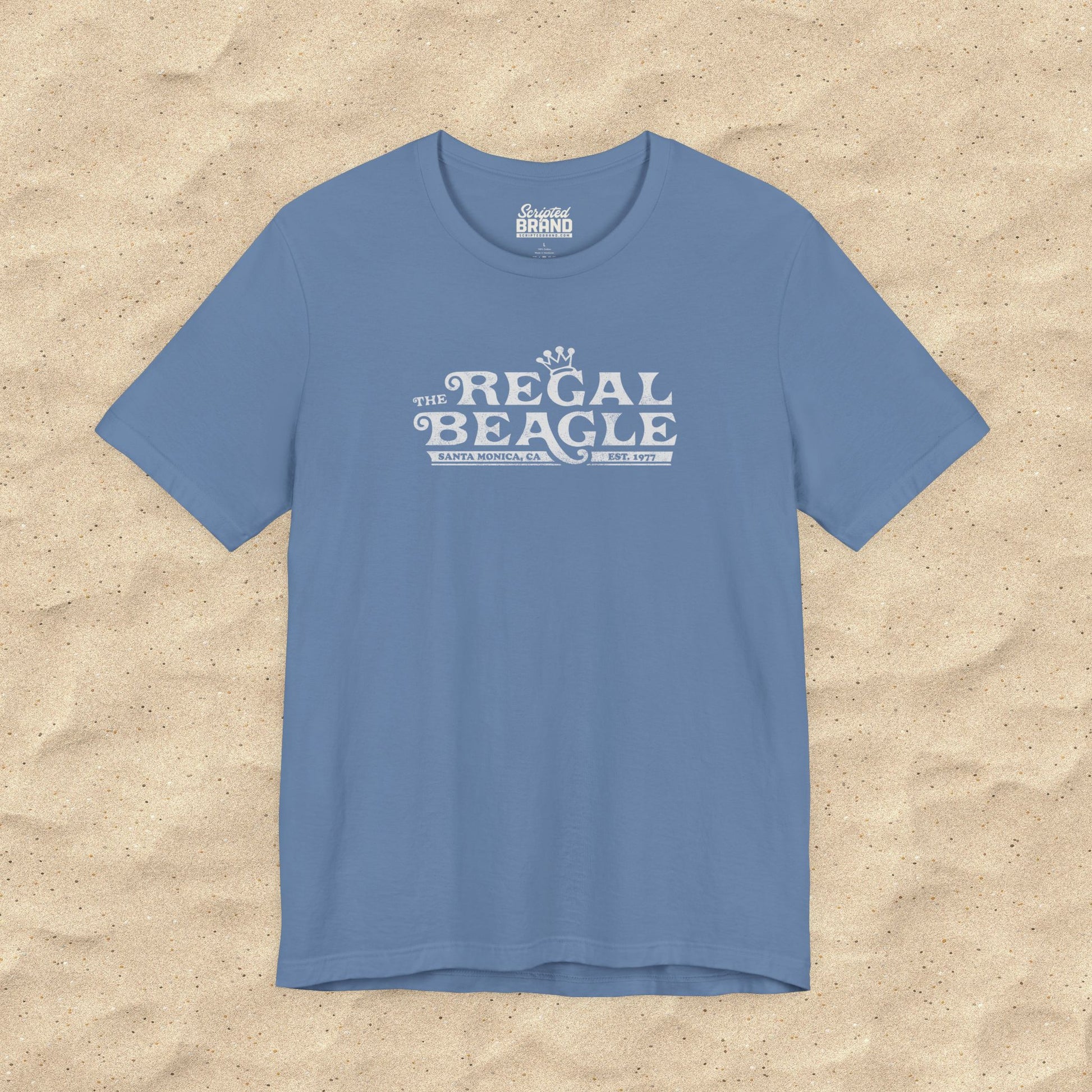Lavender Blue Bella+Canvas t-shirt with the Regal Beagle logo from the TV Show 'Threes Company' in a vintage distressed style.