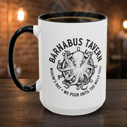 White accent mug with black handle on left and vintage Barnabus Tavern octopus ship's wheel design inspired by Widows Bay, shown in a pub.