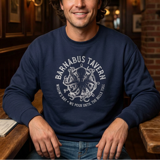 Person wearing navy crewneck sweatshirt with vintage Barnabus Tavern graphic from Widow's Bay TV show octopus design