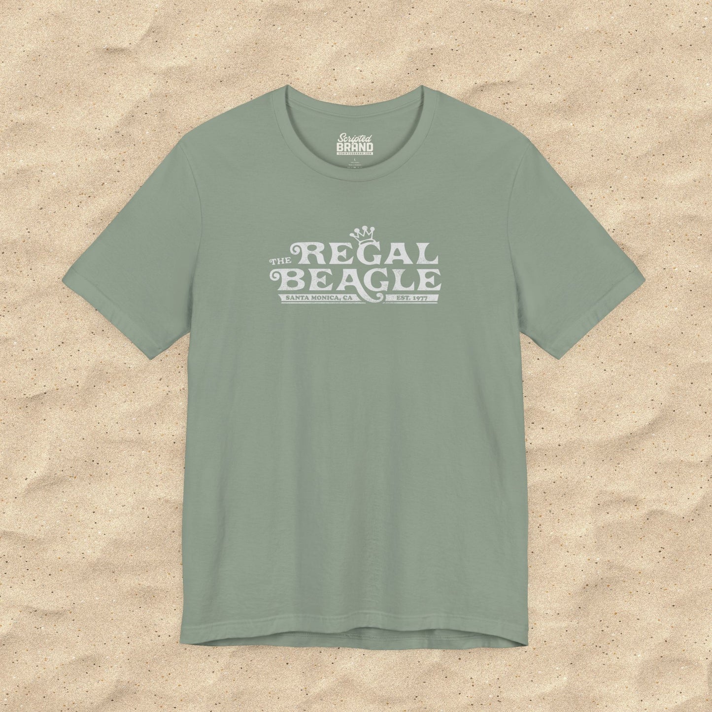 Sage green Bella+Canvas t-shirt with the Regal Beagle logo from the TV Show 'Threes Company' in a vintage distressed style.