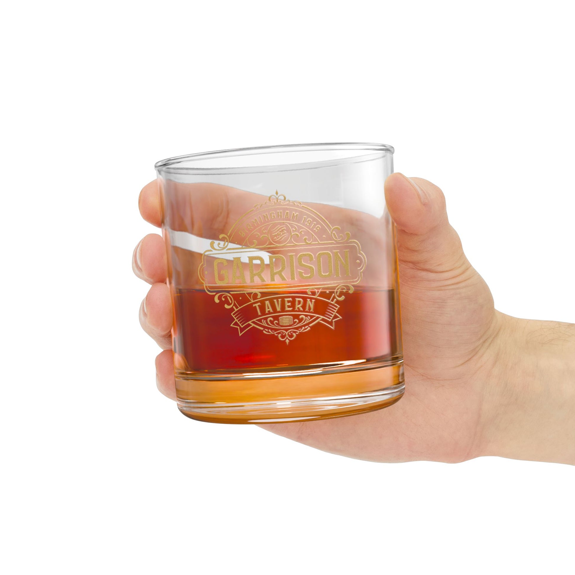 Hand holding a Garrison Tavern rocks glass with gold Birmingham 1919 logo, inspired by Peaky Blinders, 10oz whiskey lowball glass.
