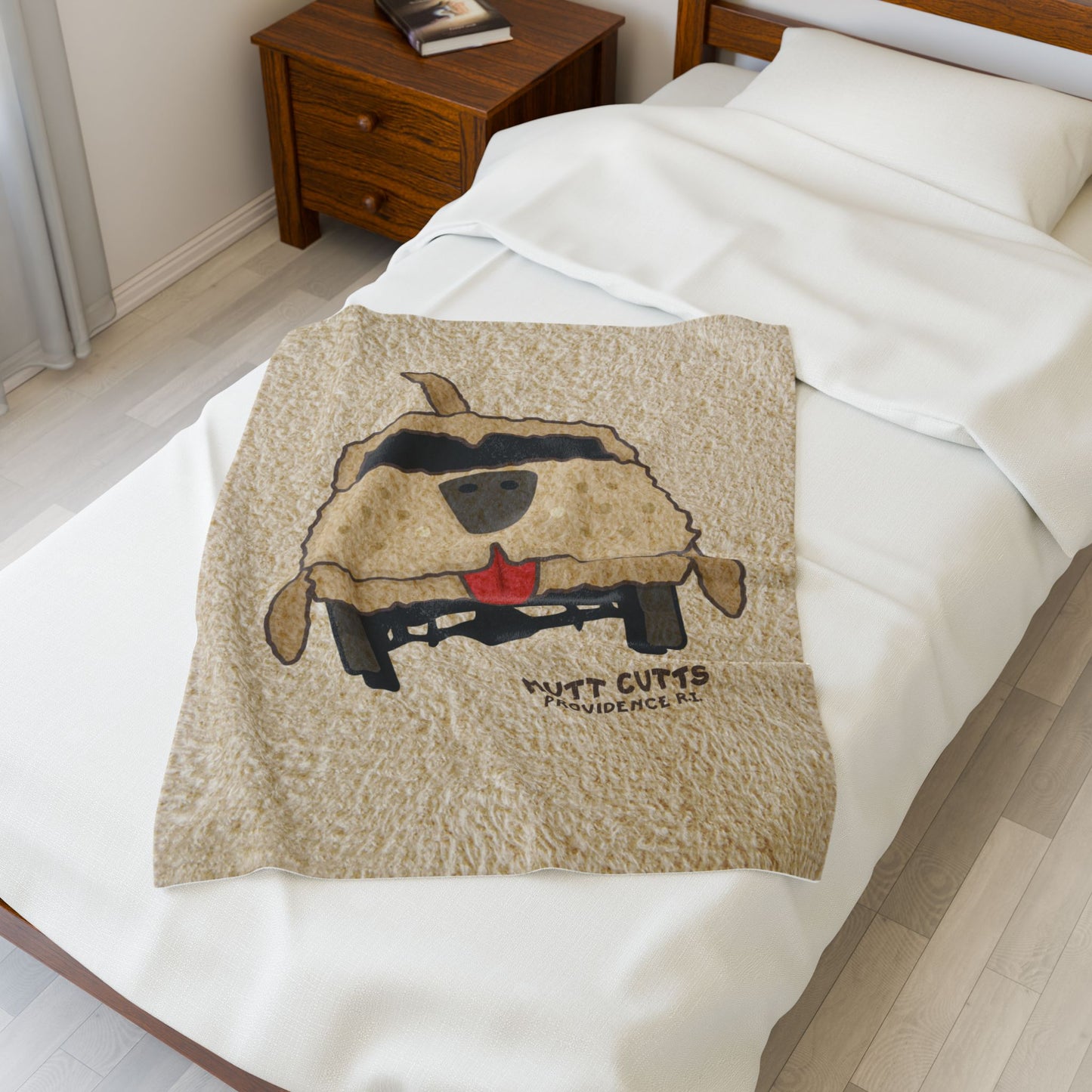 Top down view of 30x40 Velveteen plush blanket with large Mutt Cutts dog van graphic inspired by Dumb and Dumber, shown on a bed.