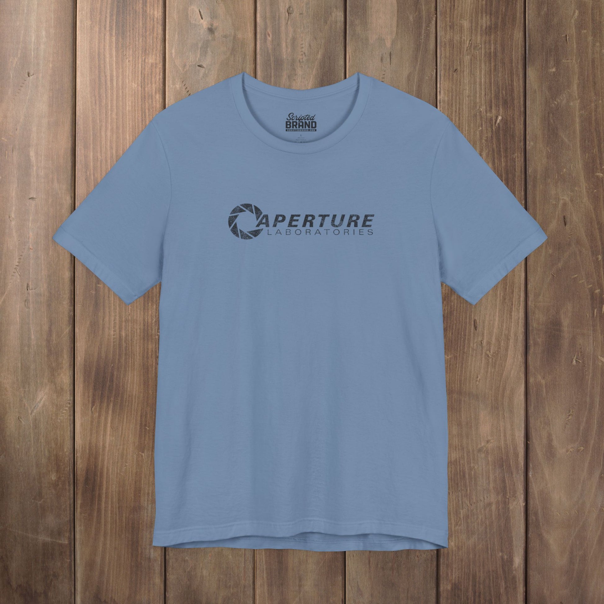 Steel blue Bella Canvas t-shirt with the Aperture Laboratories logo from the video game Portal and Portal 2 in a vintage distressed style.