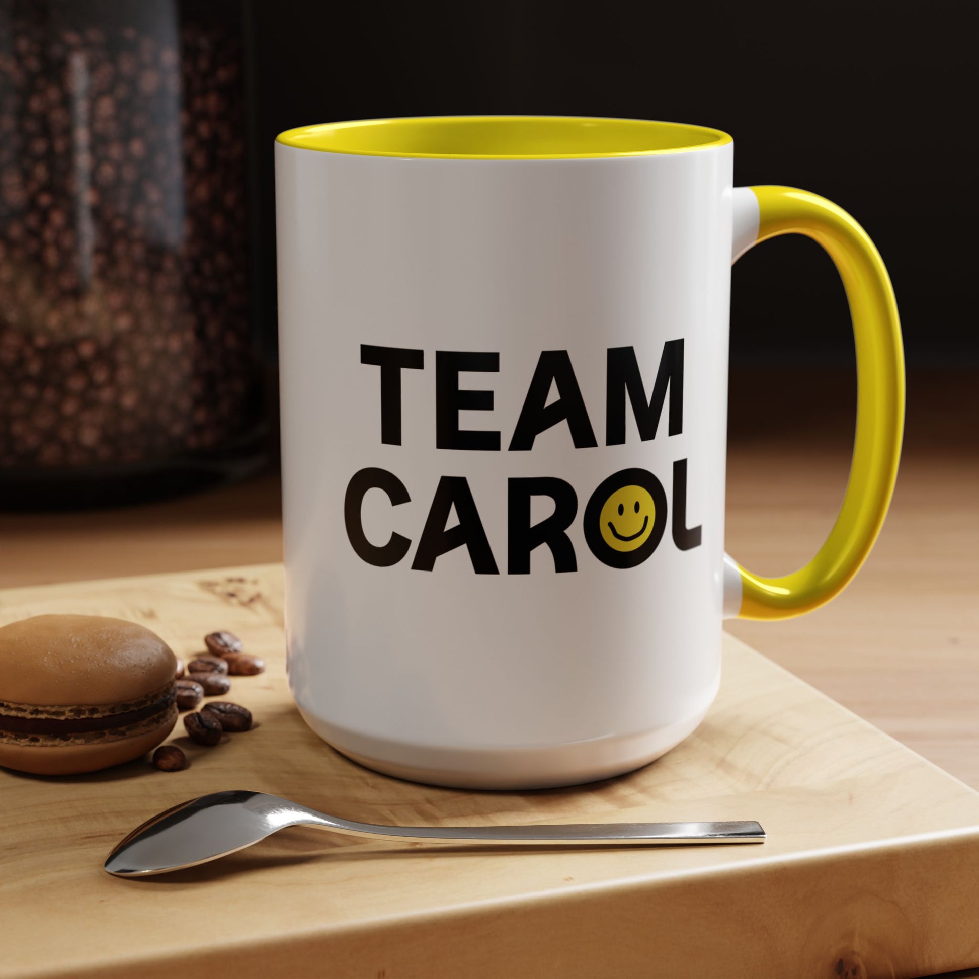 15 oz ceramic accent mug with yellow handle and interior, TEAM CAROL text and smiley face from Pluribus, shown in kitchen