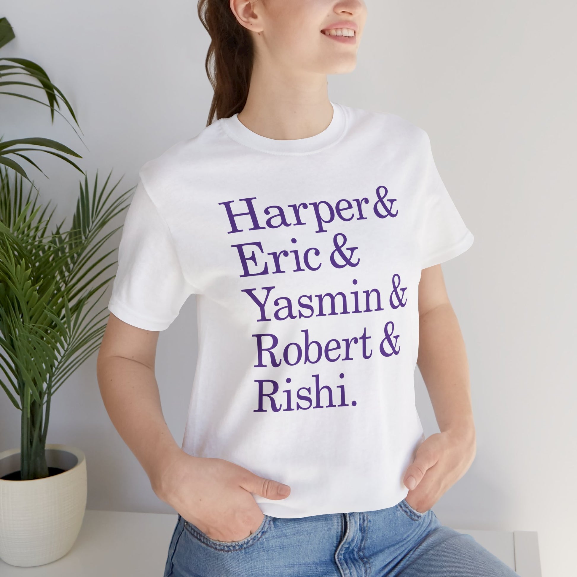 Woman wearing white t-shirt with names Harper, Eric, Yasmin, Robert & Rishi in Pierpoint & Co. font, inspired by TV show Industry.