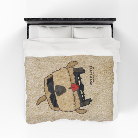 Top down view of 60x80 Velveteen plush blanket with large Mutt Cutts dog van graphic inspired by Dumb and Dumber, shown on a bed.