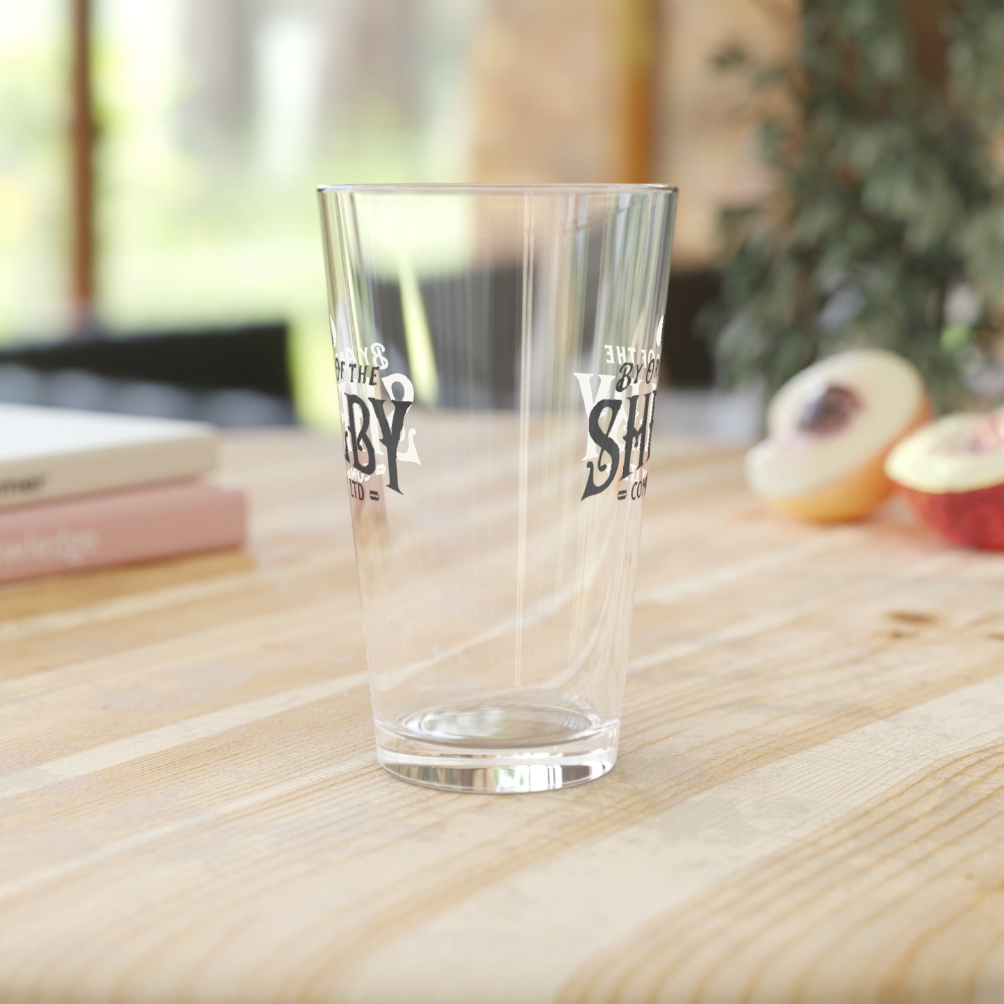 Side view of 16 ounce Pint Glass with Shelby Company LTD logo from Peaky Blinders printed on both sides, shown in a kitchen.