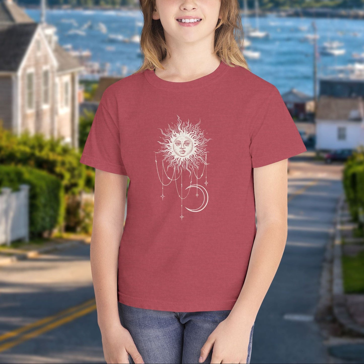 Girl wearing Crimson youth tee with Patricia boho celestial sun, stars, and crescent moon design from Widow's Bay
