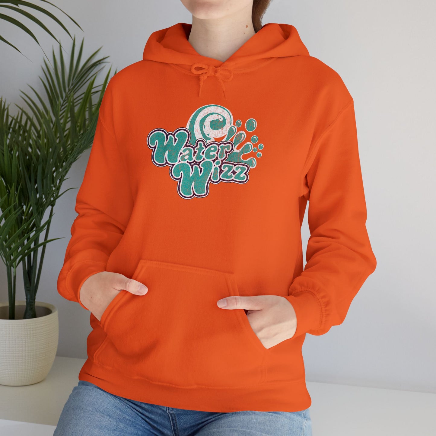 Woman wearing orange Gildan 18500 pullover hoodie with vintage distressed Water Wizz logo from Grown Ups on the chest.